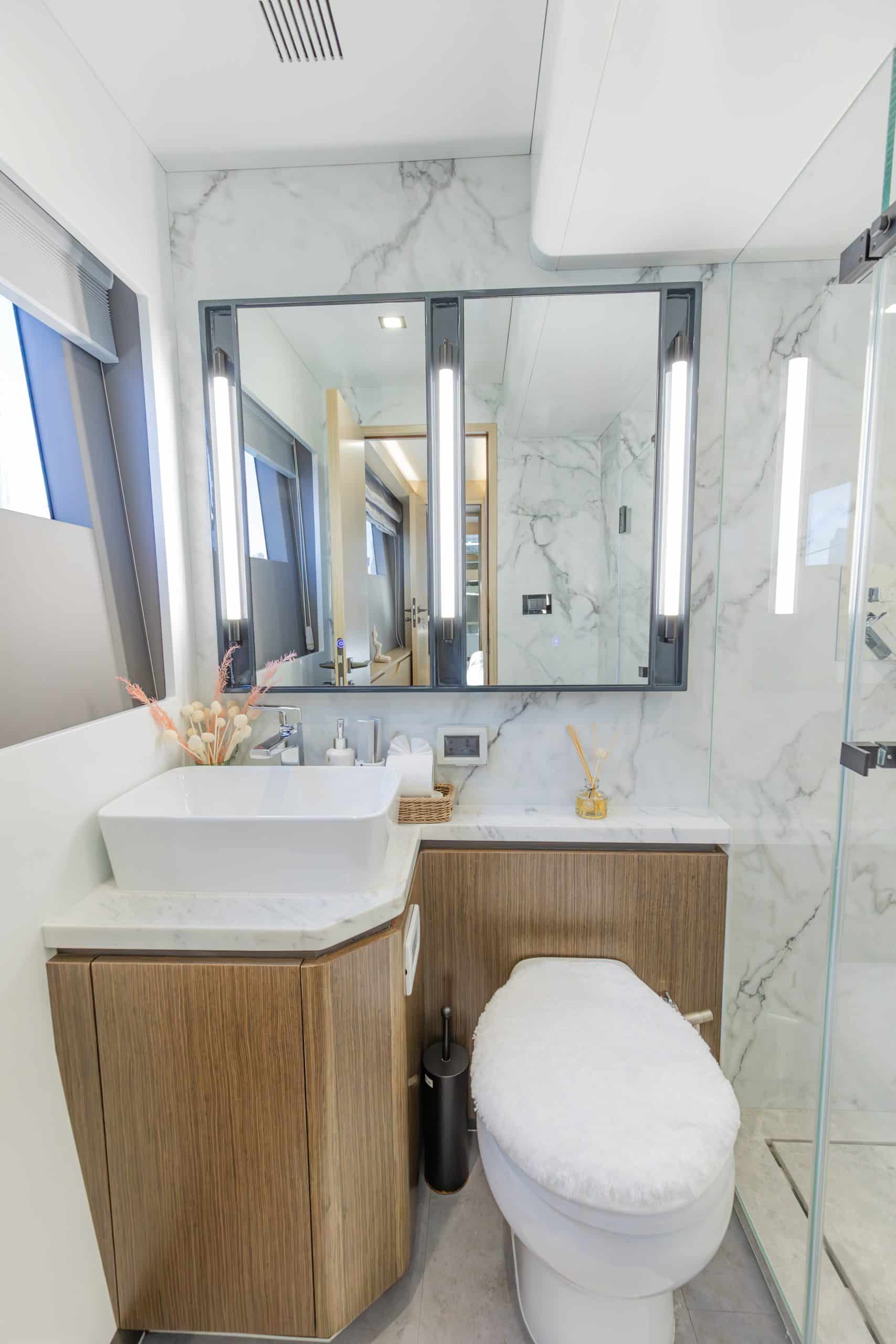 Zirve 72 luxury yacht bathroom with glass shower enclosure and wooden vanity