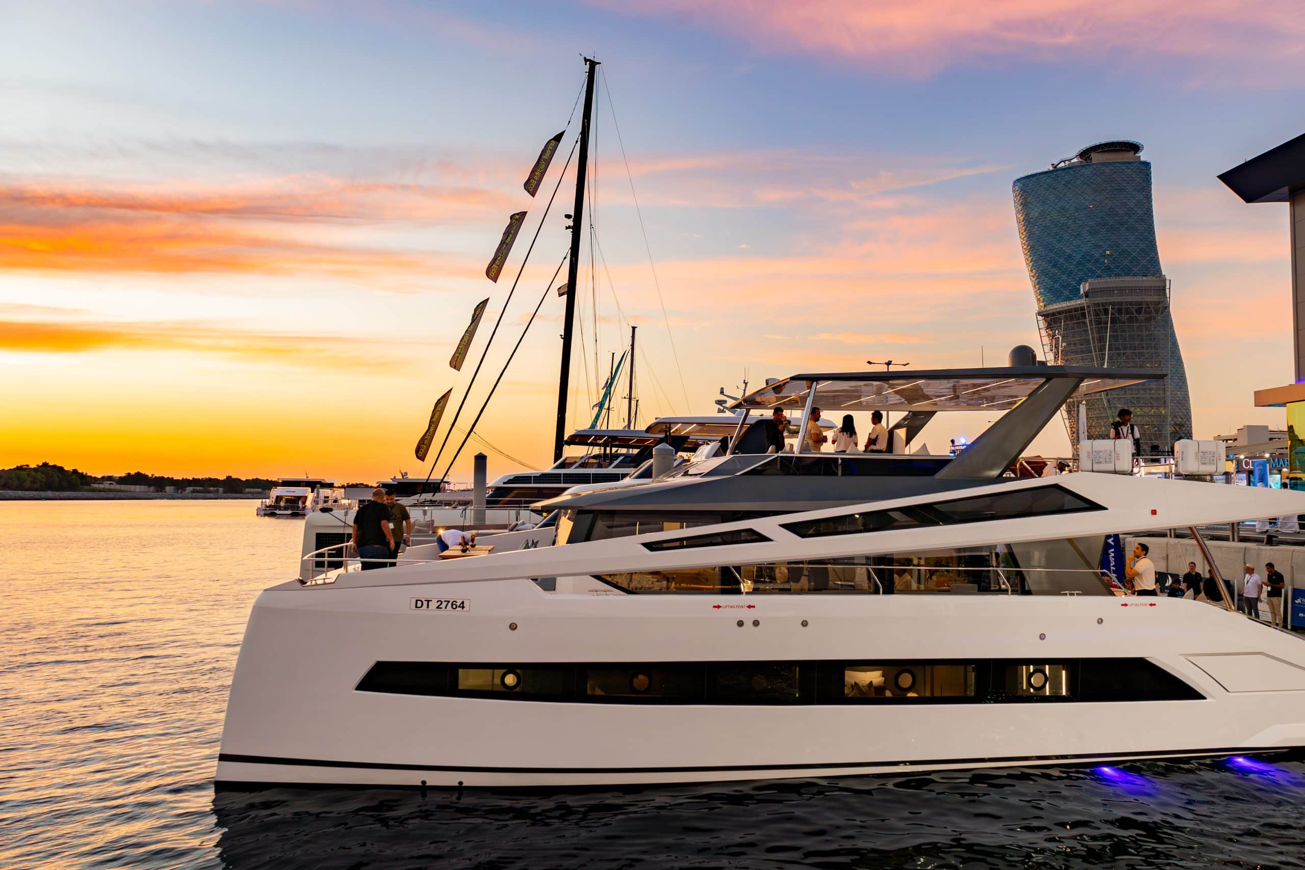 Zirve 72 yacht docked at sunset with warm sky reflections on the water