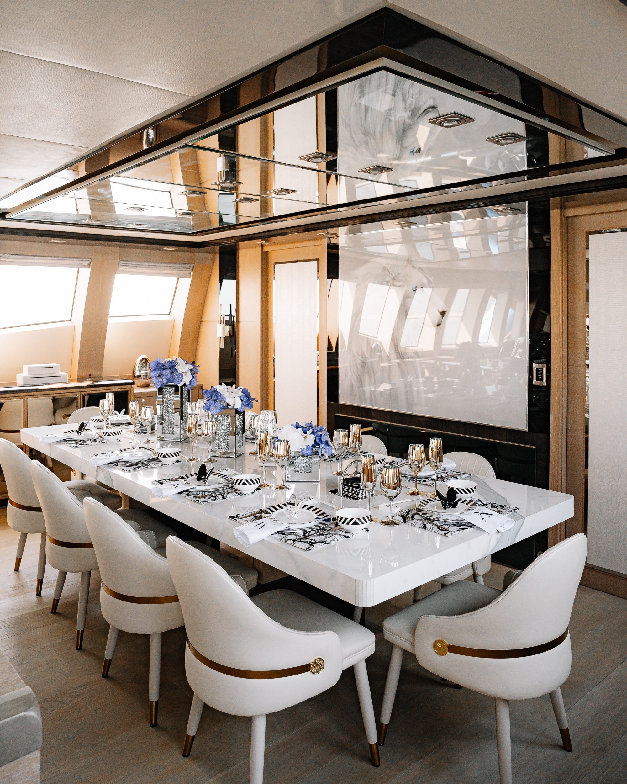 Royalty 136 luxury yacht formal dining area with elegant table setup and panoramic windows