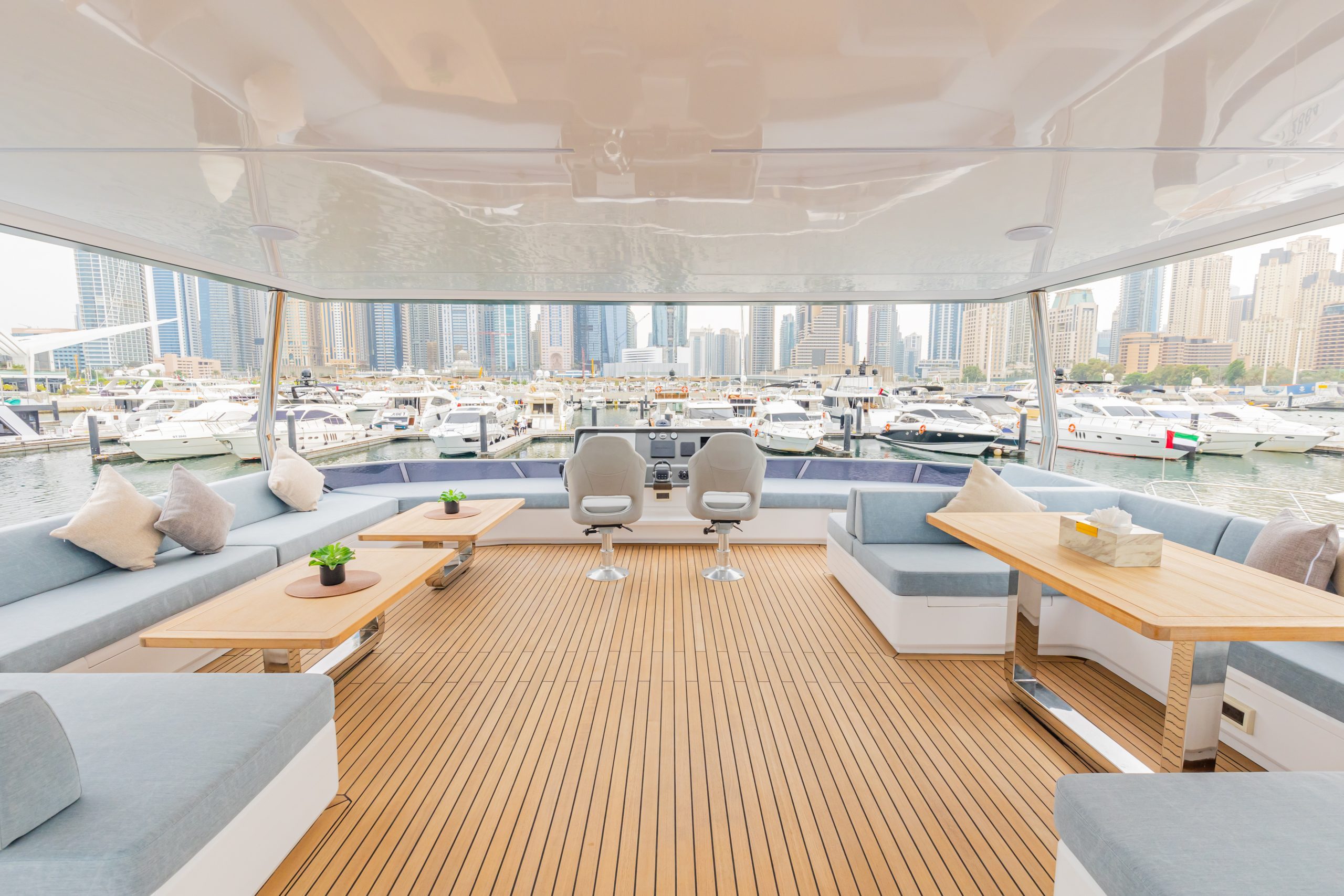Spacious upper deck seating area on the Zirve 72 yacht with panoramic marina views