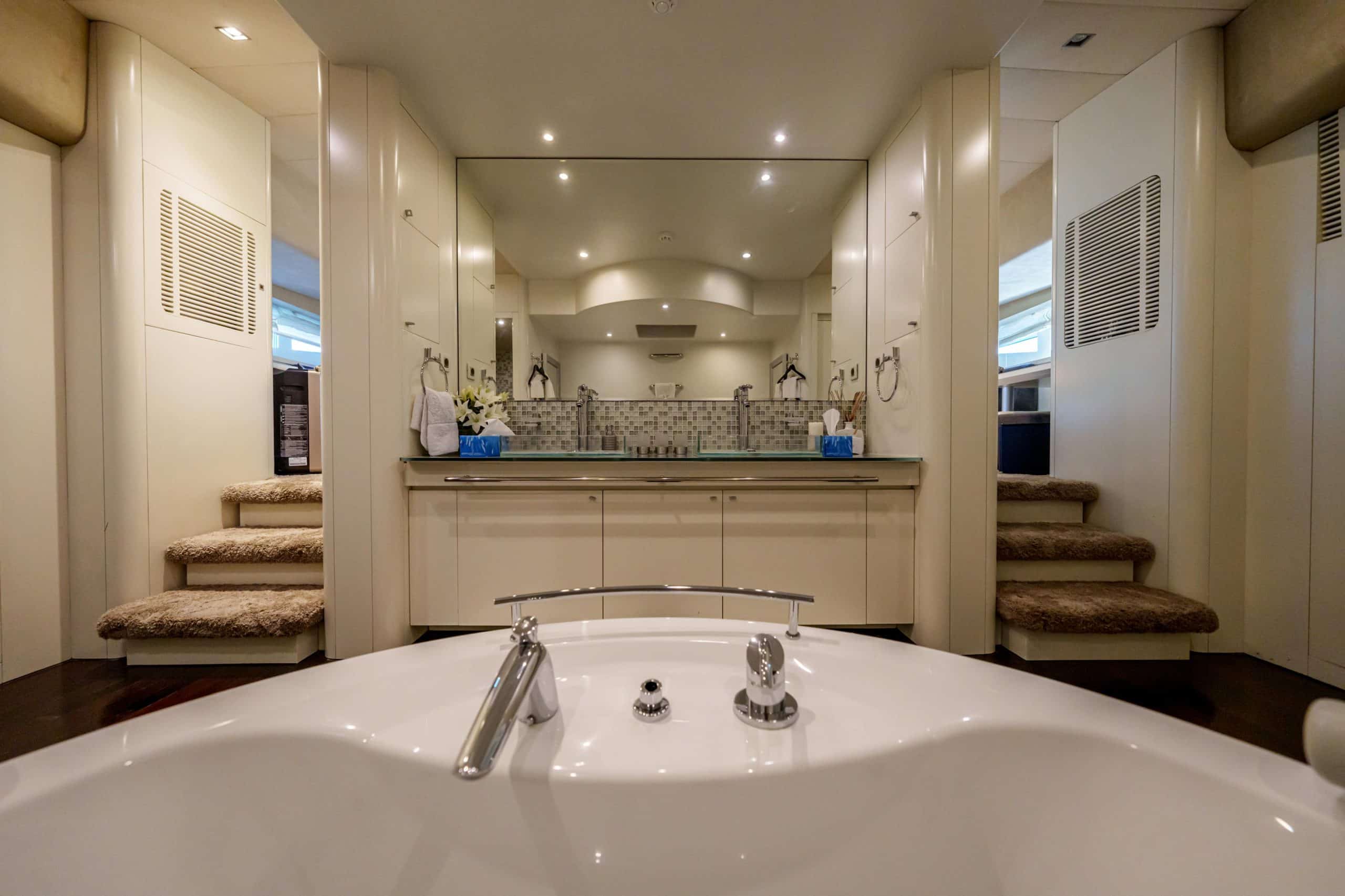 Modern yacht vanity and sink area inside Tatti 110 bathroom