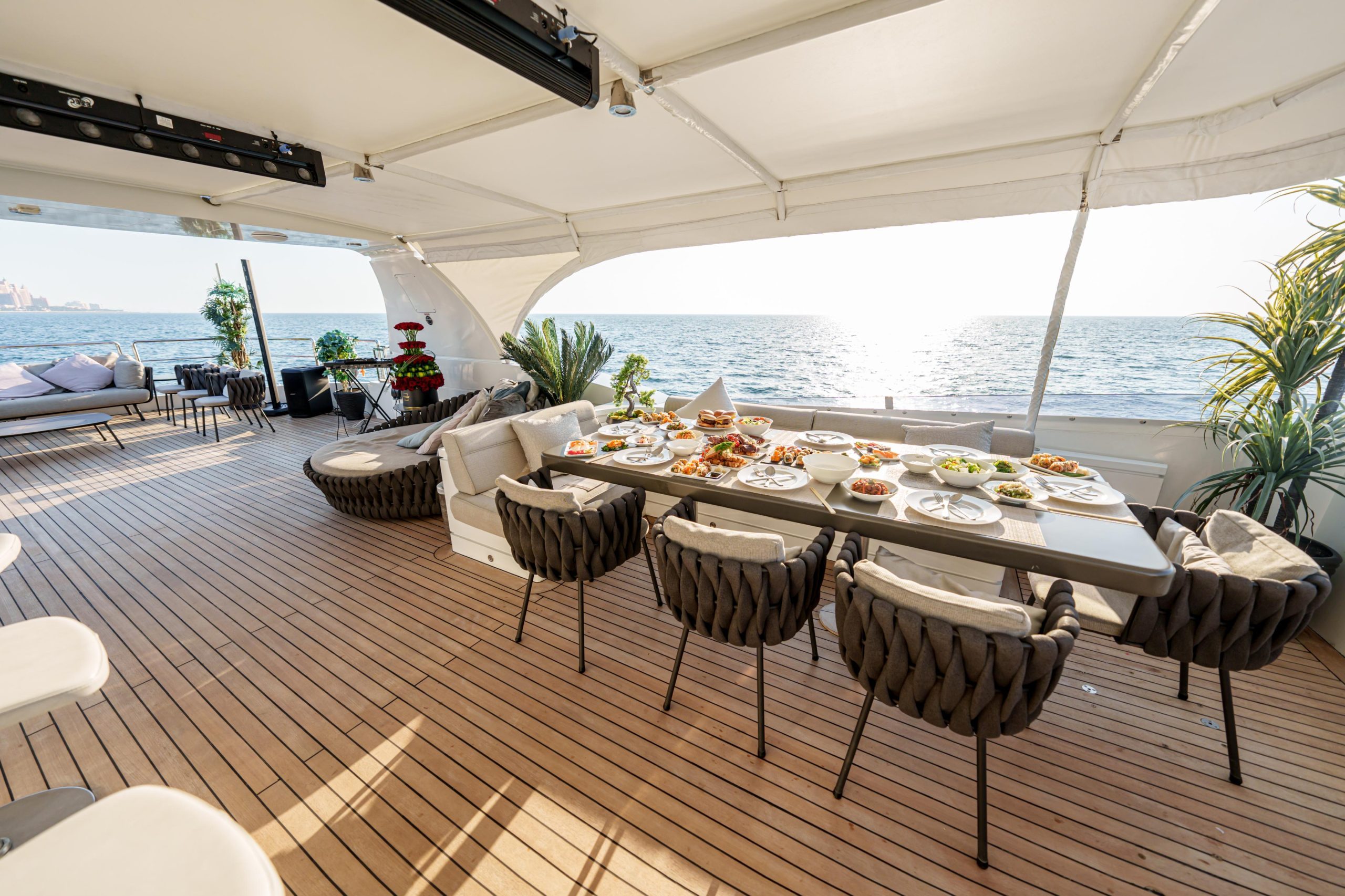 Spacious shaded dining and seating area on Tatti 110 yacht deck