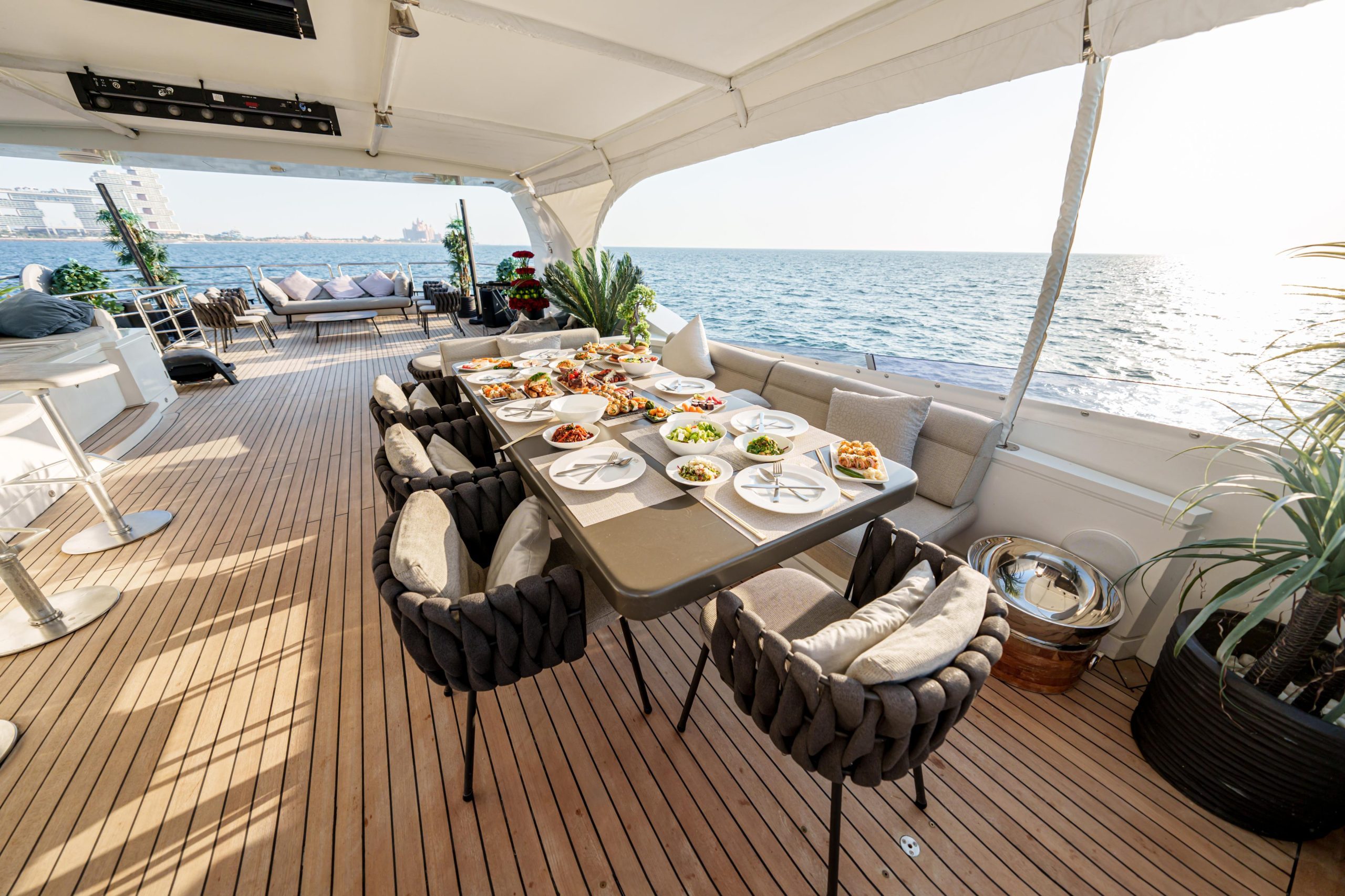 Comfortable outdoor lounge seating with sea view on Tatti 110 yacht