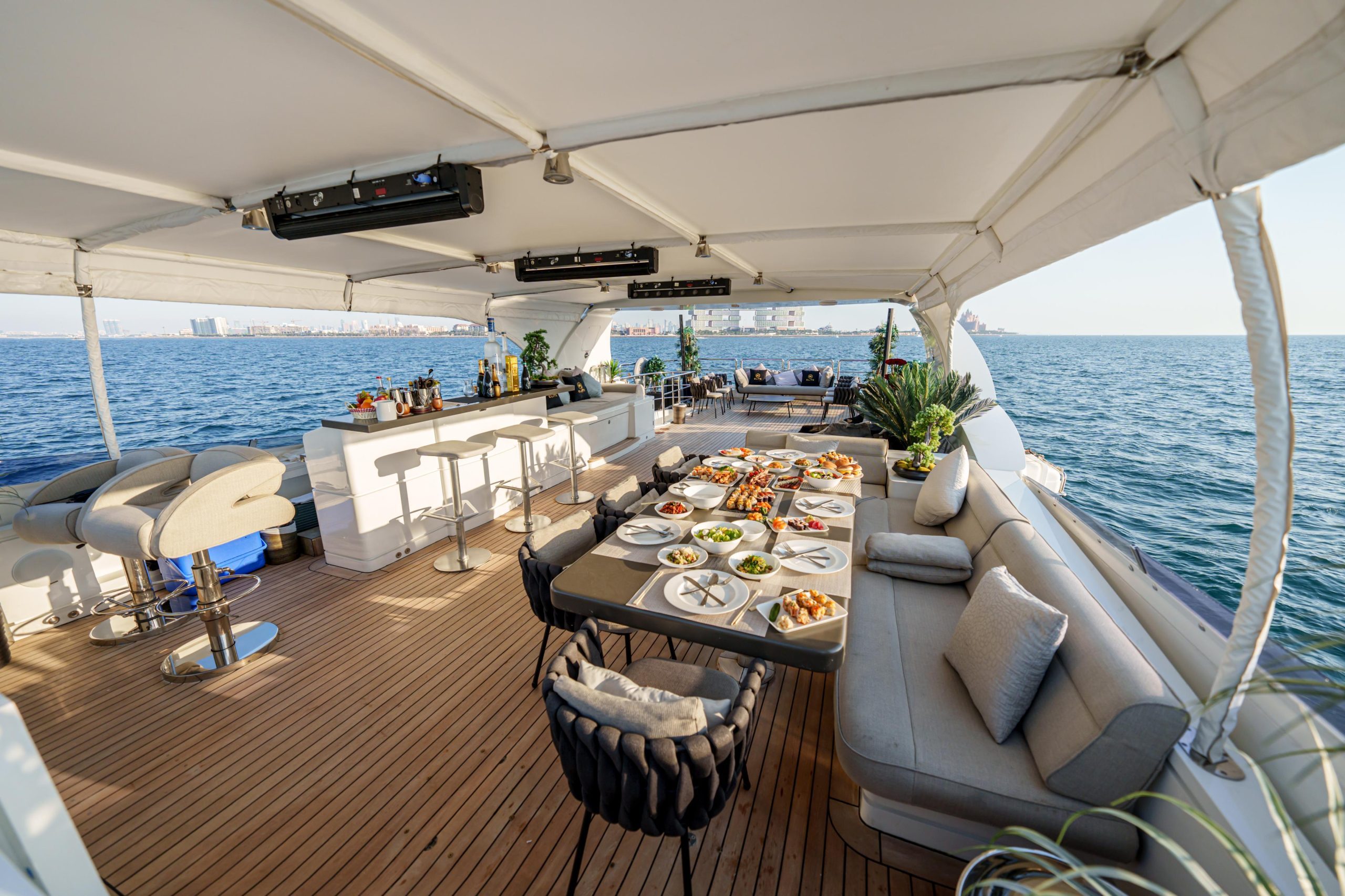 Tatti 110 yacht flybridge seating area with dining setup
