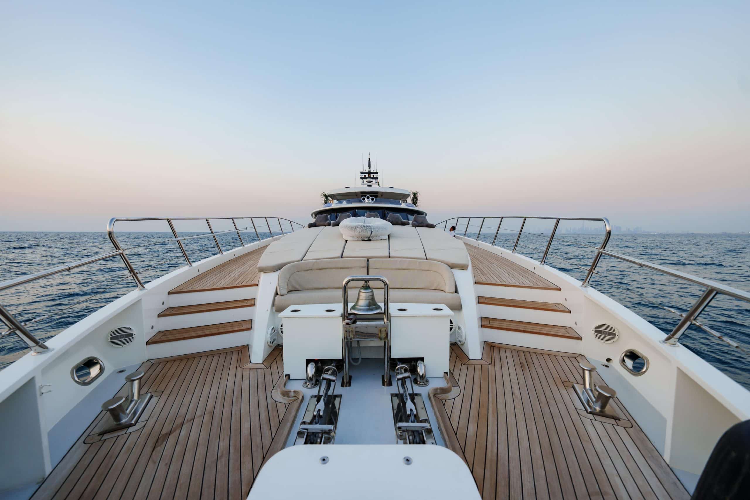 Tatti 110 yacht bow deck with sun loungers and teak flooring