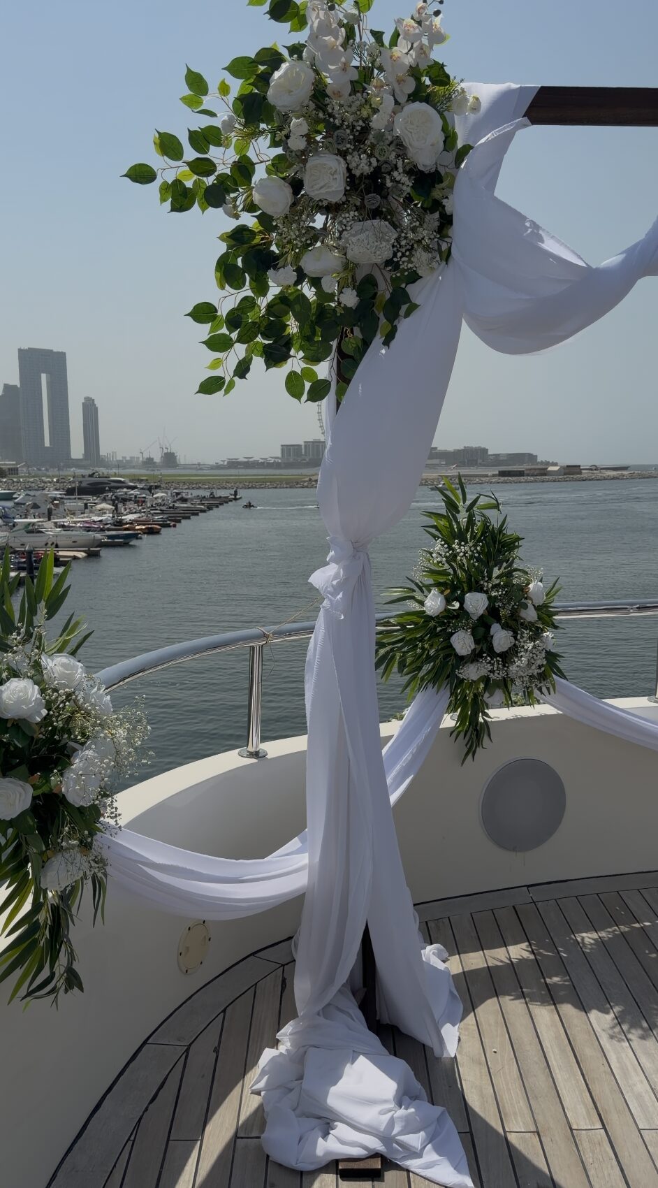 elegant yacht wedding decoration with floral arrangement and sea backdrop