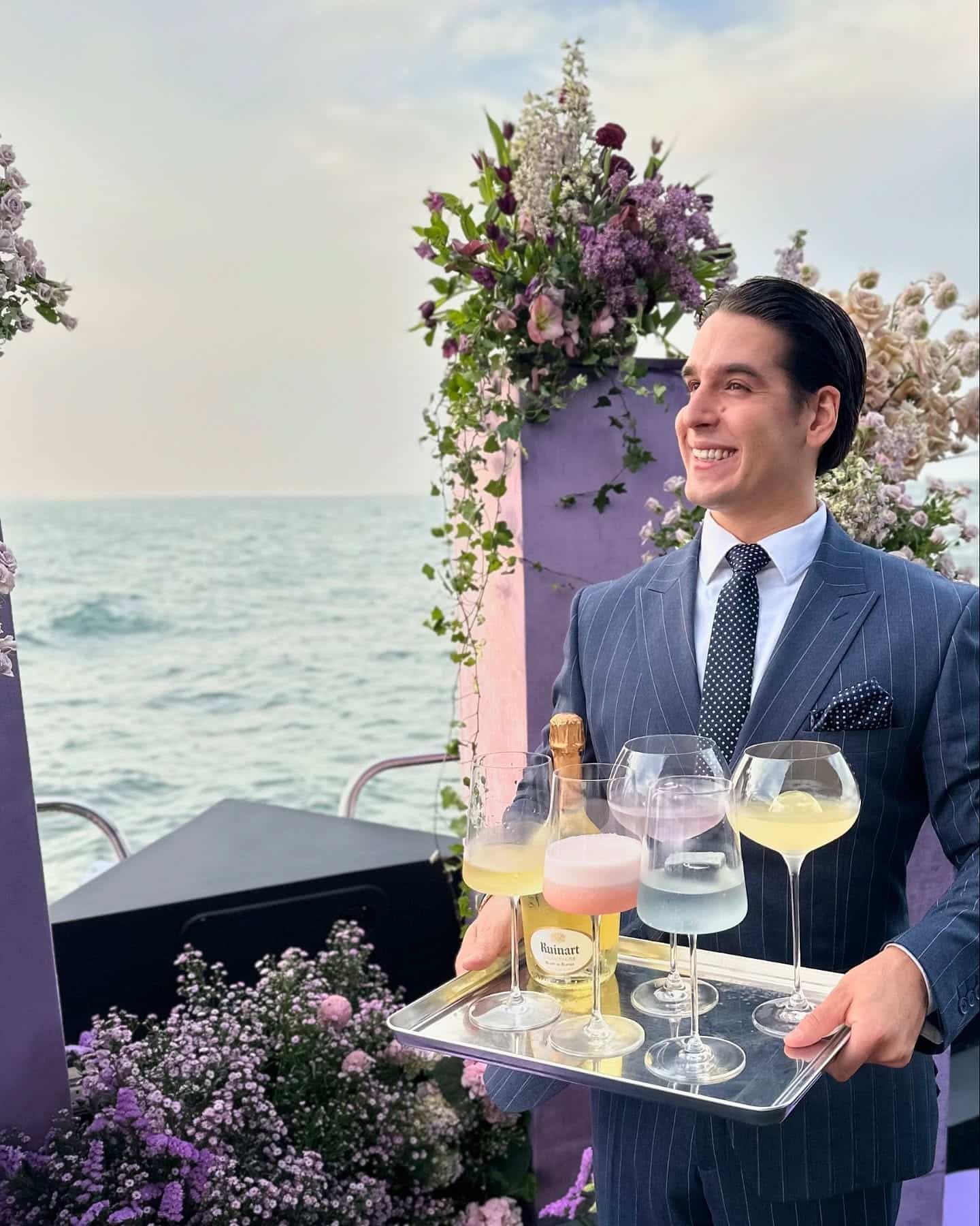professional yacht bartender serving drinks to guest during luxury yacht experience