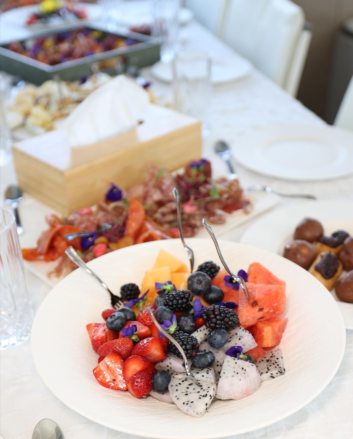 Gourmet dessert plate with fresh berries and pastries served on a luxury yacht