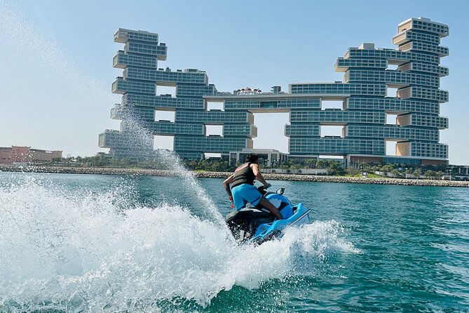 Rider speeding on jet ski in Dubai with water splashes and city background