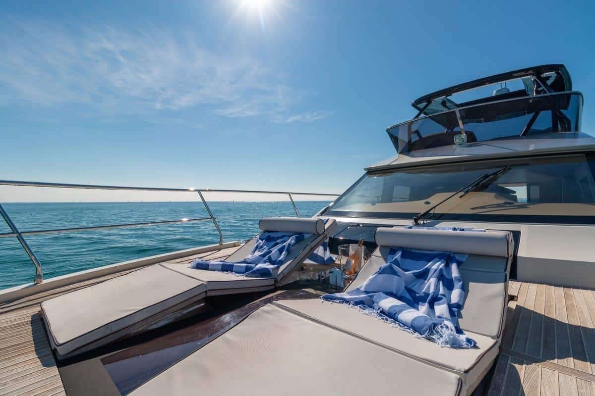 Monaco 60 yacht sun deck lounge with cushioned seating and ocean backdrop