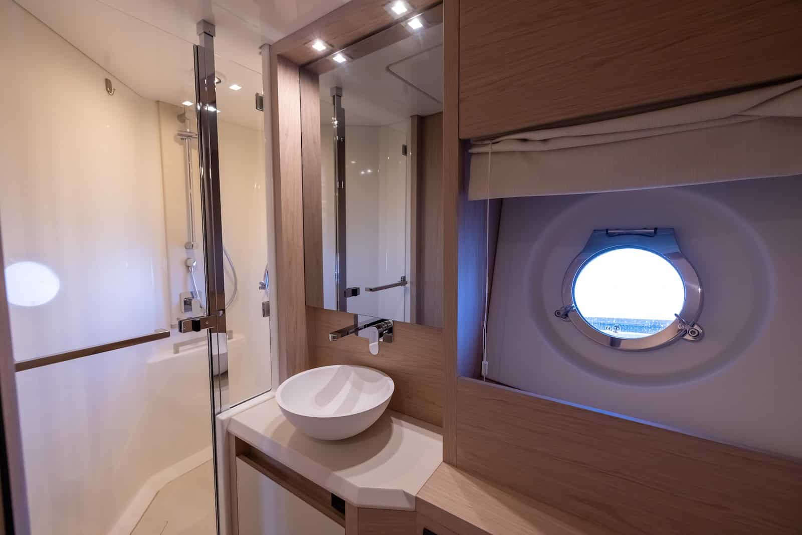 Monaco 60 yacht bathroom with modern shower and wooden finish interior