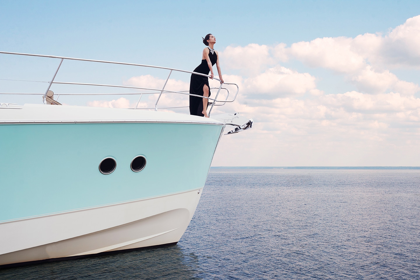Guest standing on Monaco 60 yacht bow enjoying open sea view in Dubai