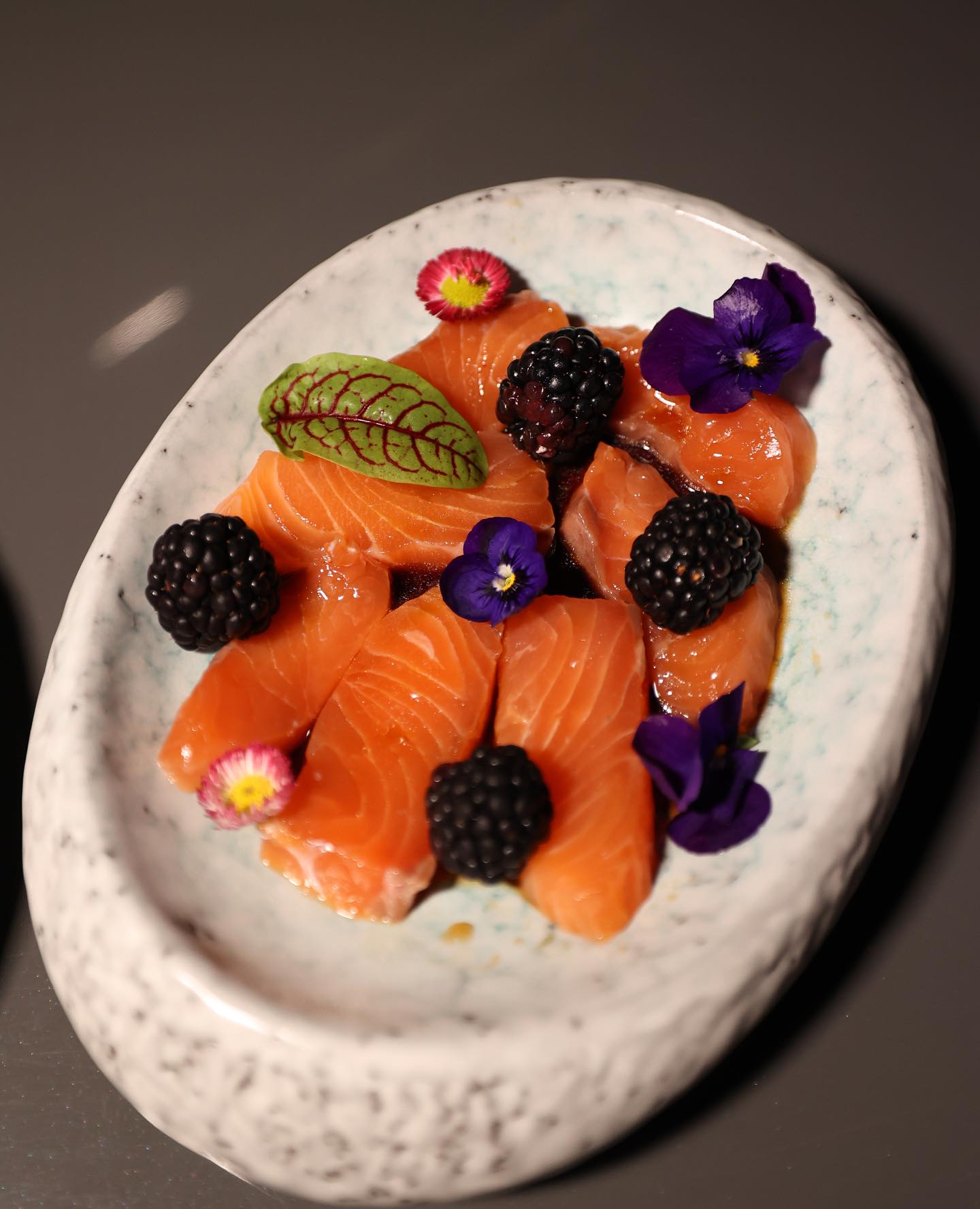 Gourmet salmon canapes with berries and edible flowers served during a luxury yacht dinner in Dubai