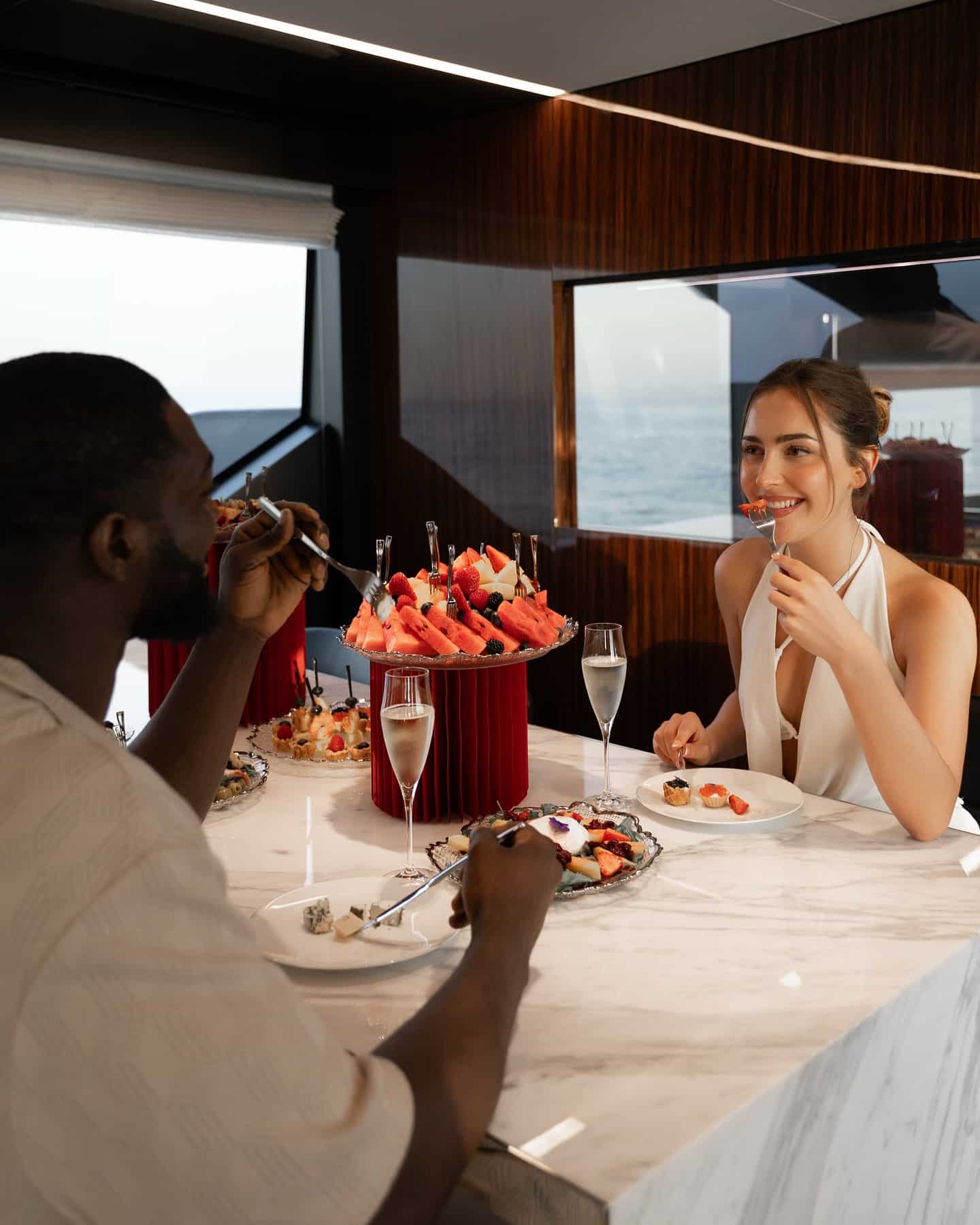 Couple enjoying a private romantic dinner inside a luxury yacht cabin in Dubai
