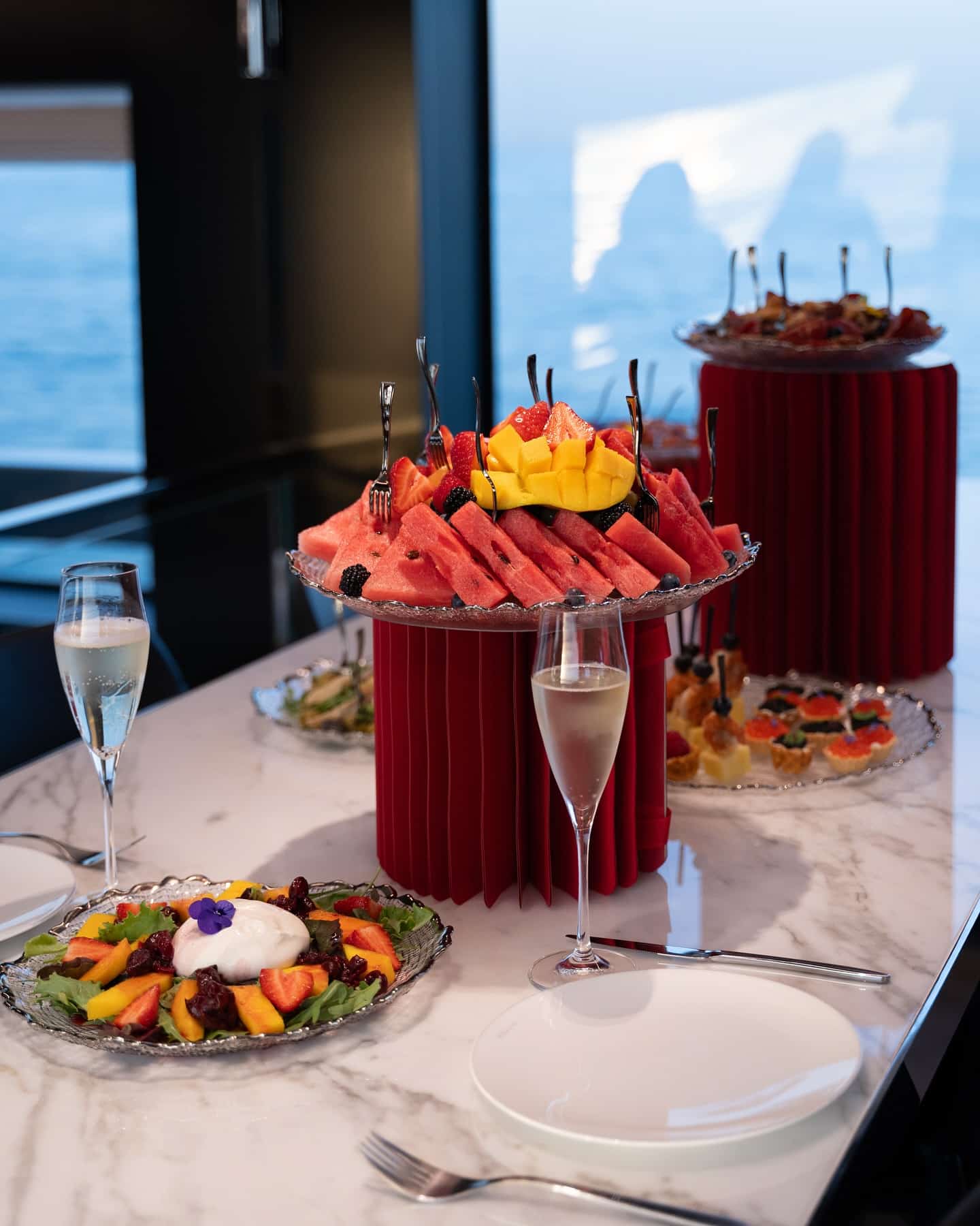 Elegant romantic dinner setup inside a luxury yacht in Dubai with floral arrangements and champagne