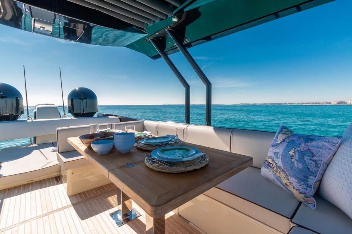 Monaco 60 yacht flybridge dining area with luxury seating and sea views