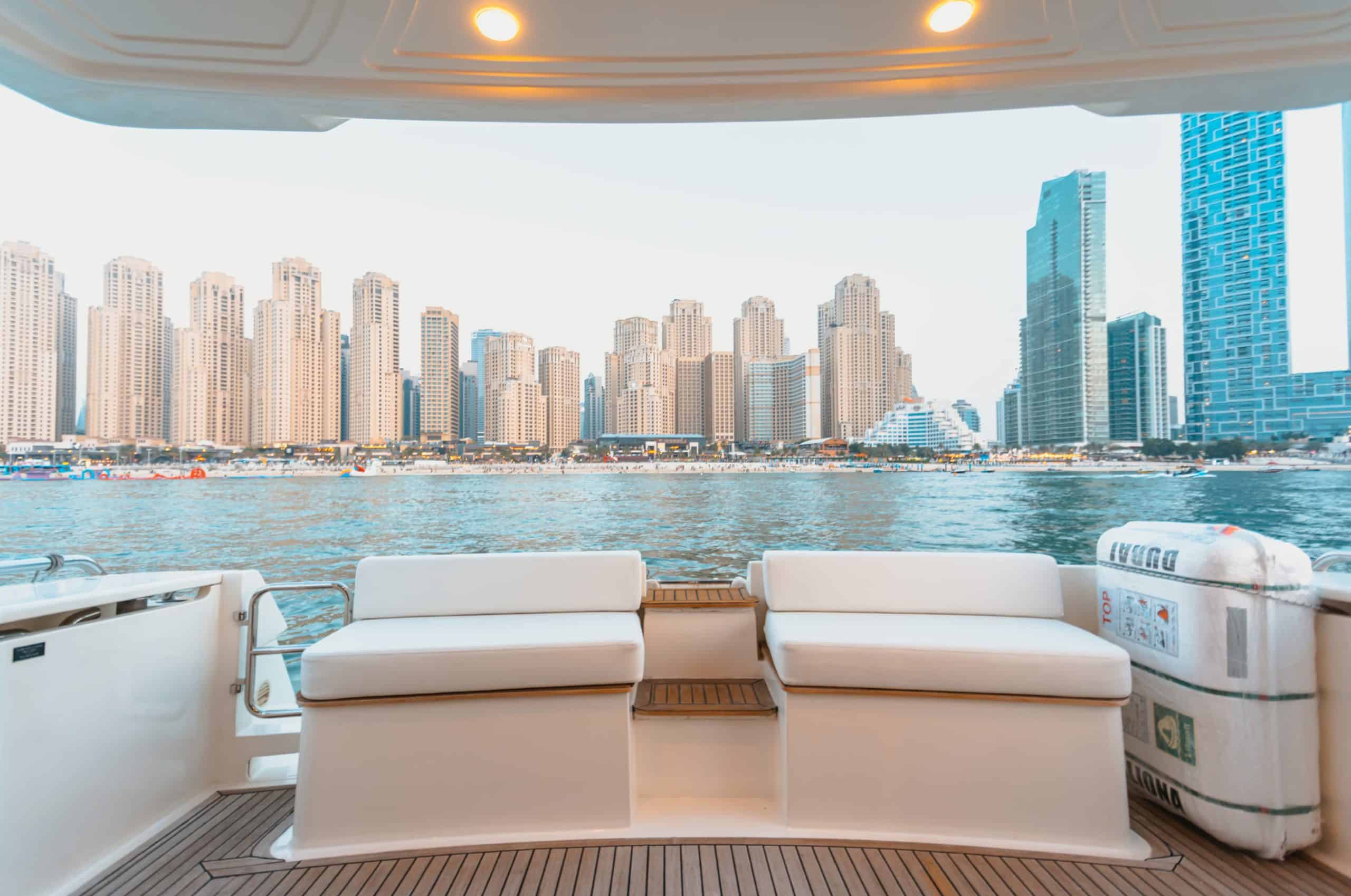 Elise 50 yacht aft deck lounge with sofa seating overlooking Dubai Marina