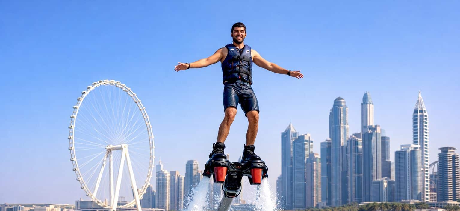 Man performing fly board water sports in Dubai with yacht and skyline view