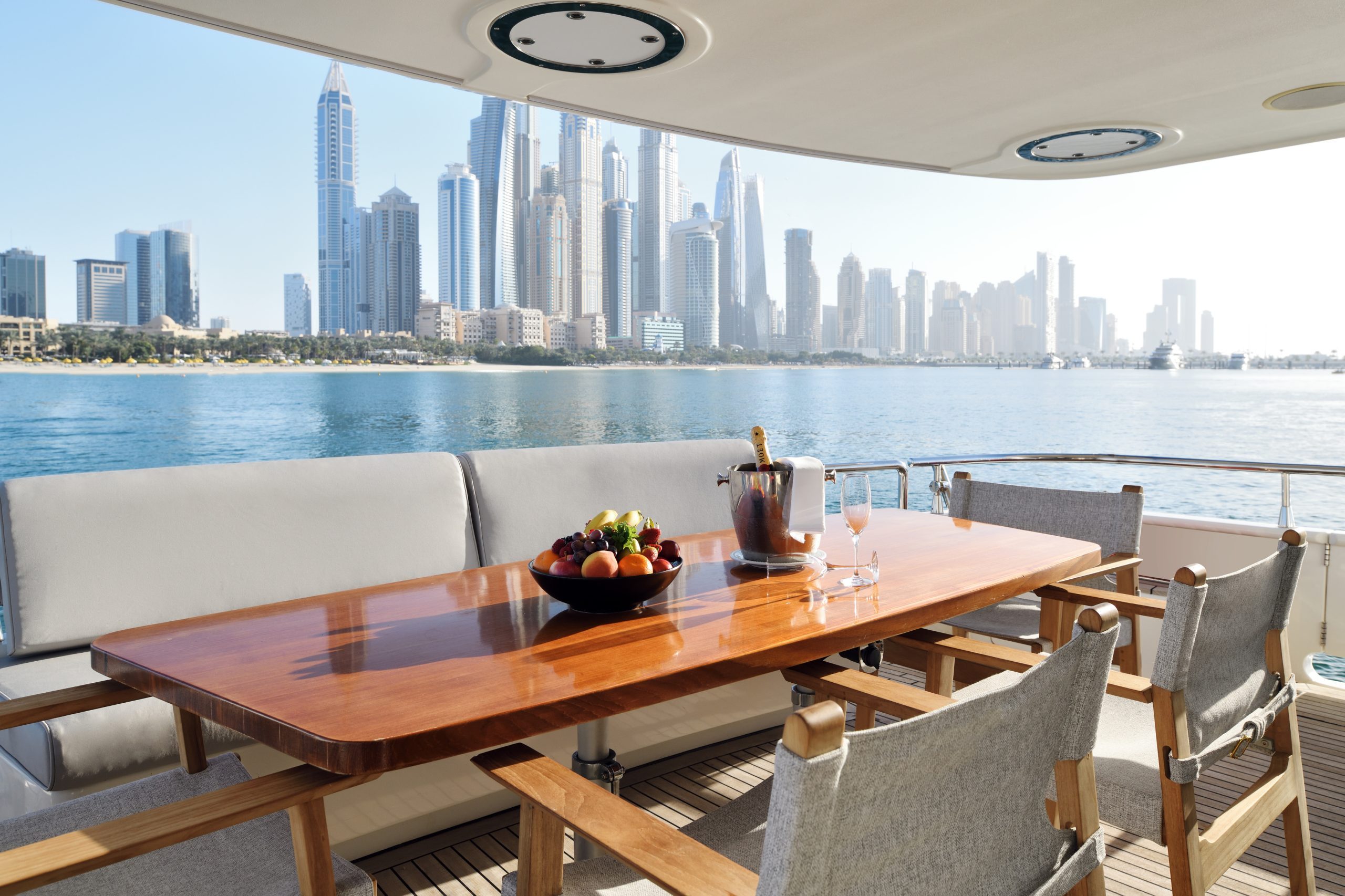 Yacht outdoor dining table with Dubai skyline backdrop