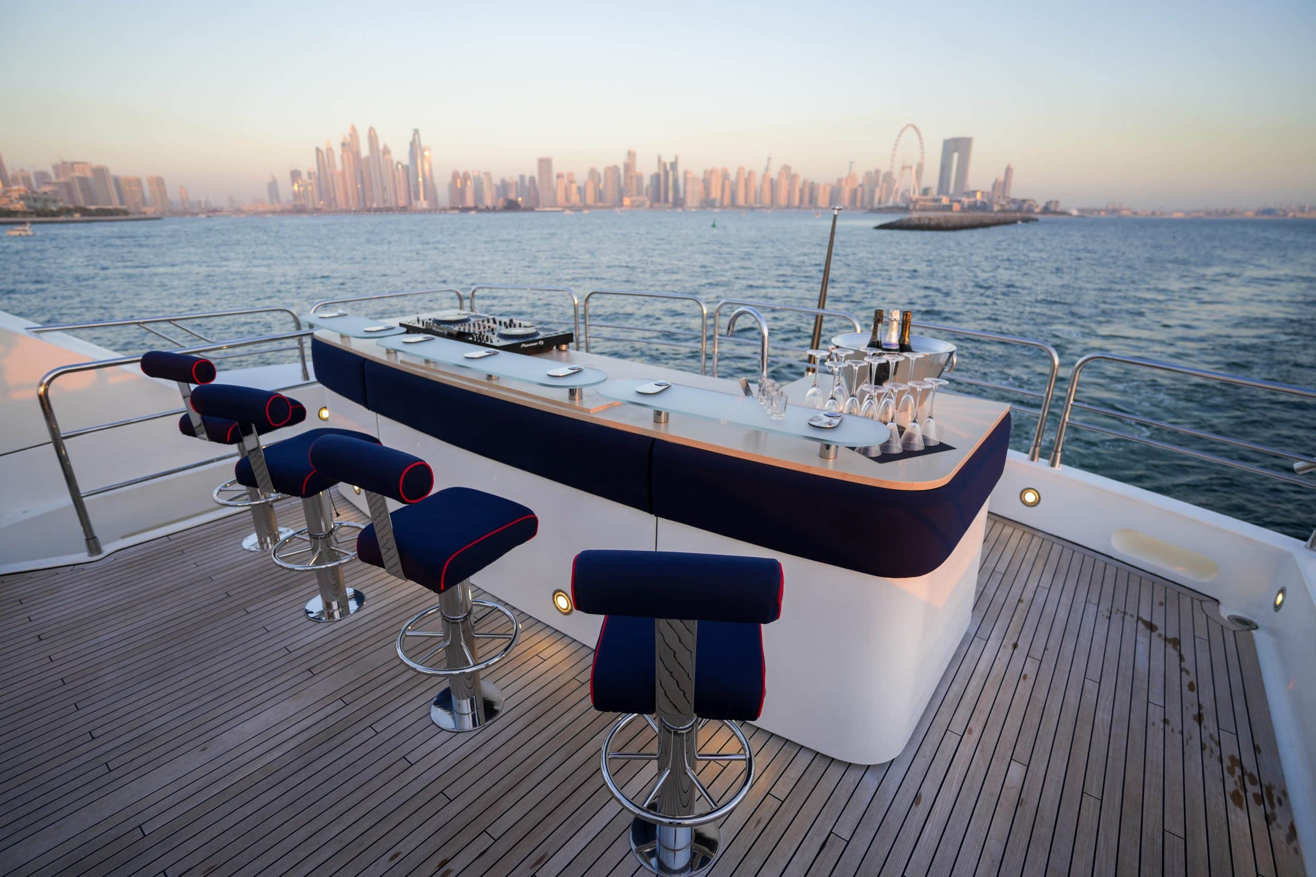 Foredeck lounge seating on Sunseeker 131 yacht with Dubai skyline view