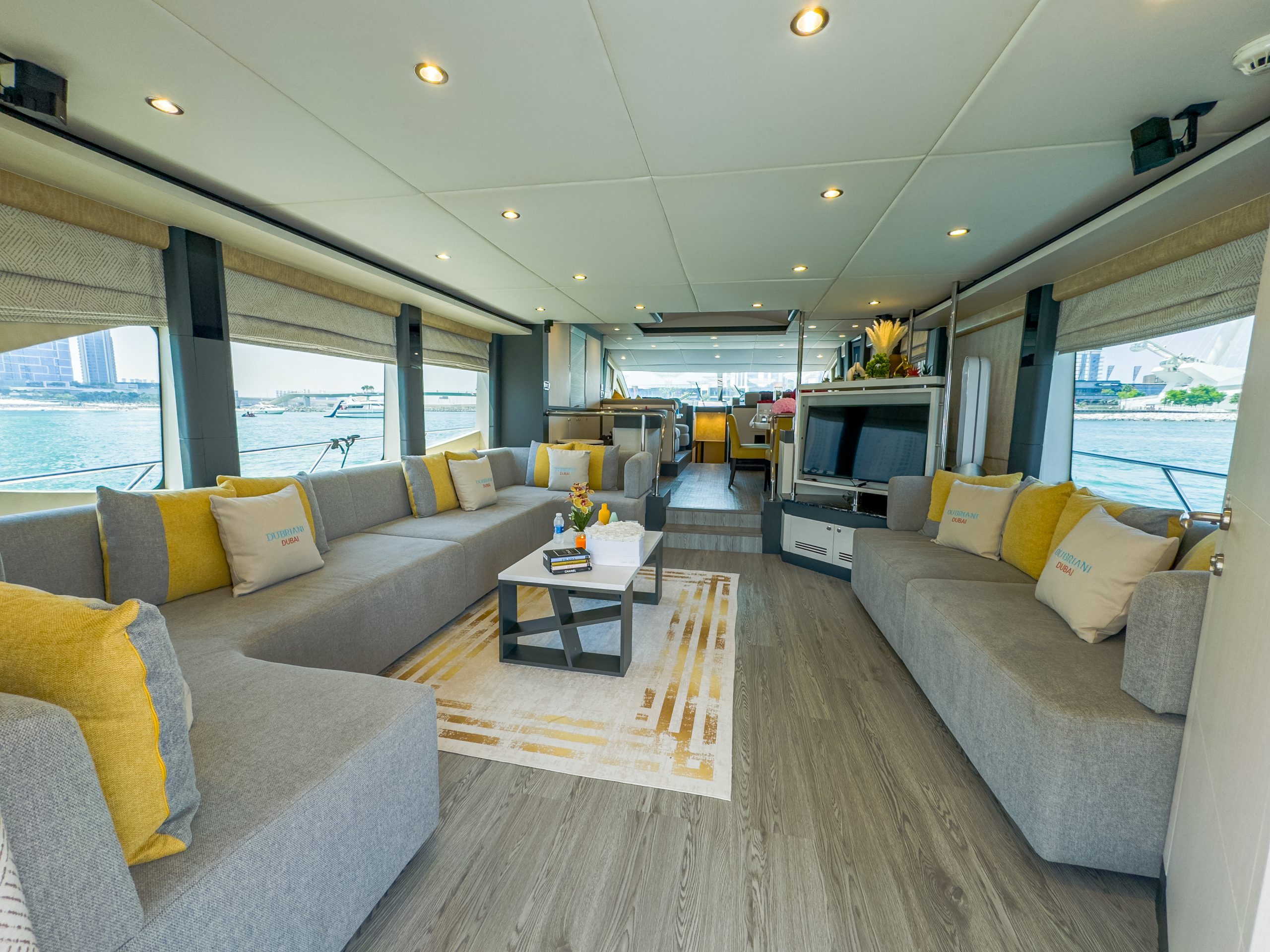 Cabo 77 yacht luxury lounge seating with wooden flooring and large windows