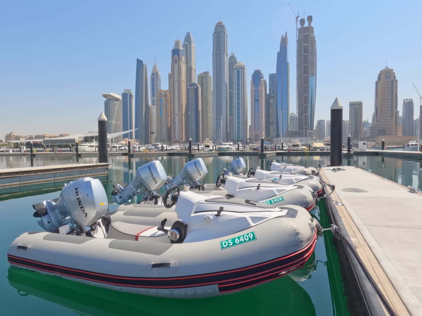 Self-drive inflatable boat docked near Dubai Marina skyline