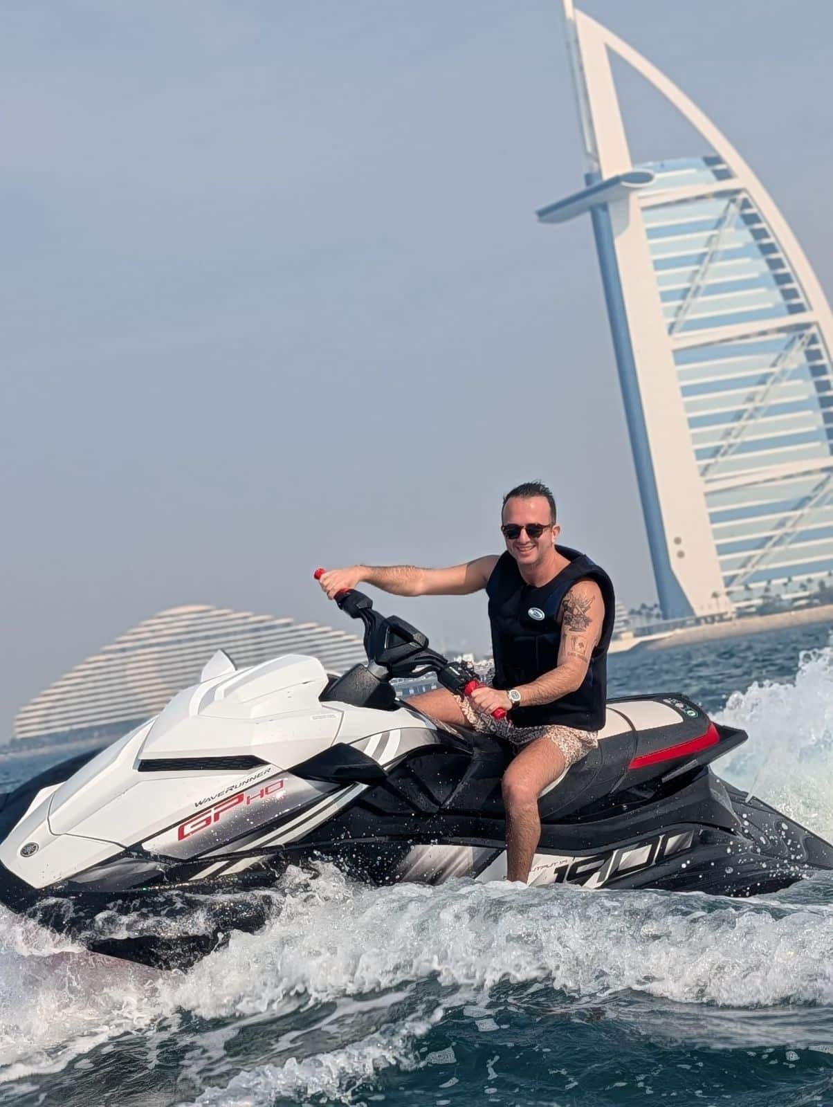 Man riding jet ski near Burj Al Arab in Dubai