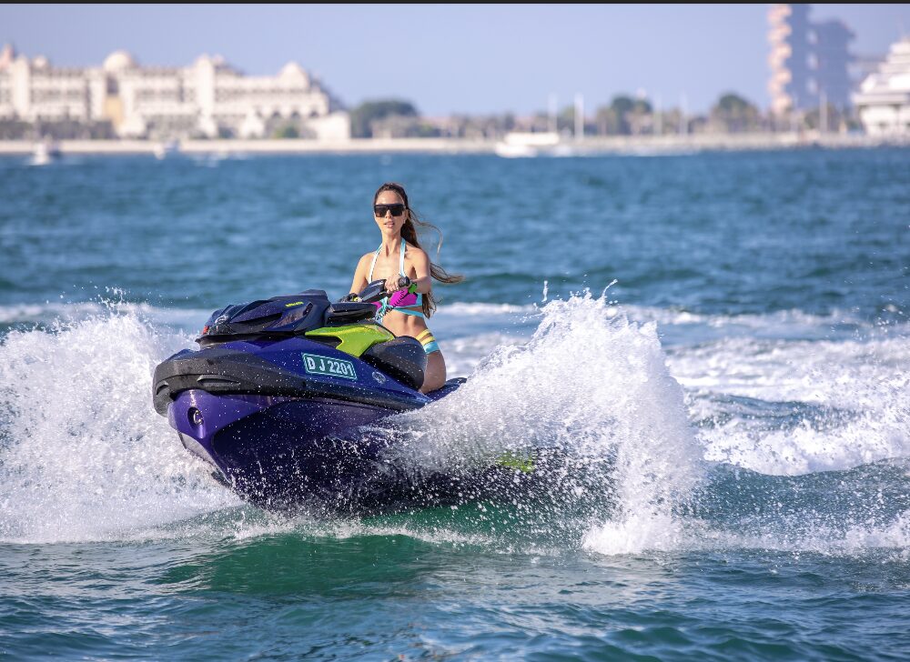 person riding jet ski during luxury yacht watersports activity