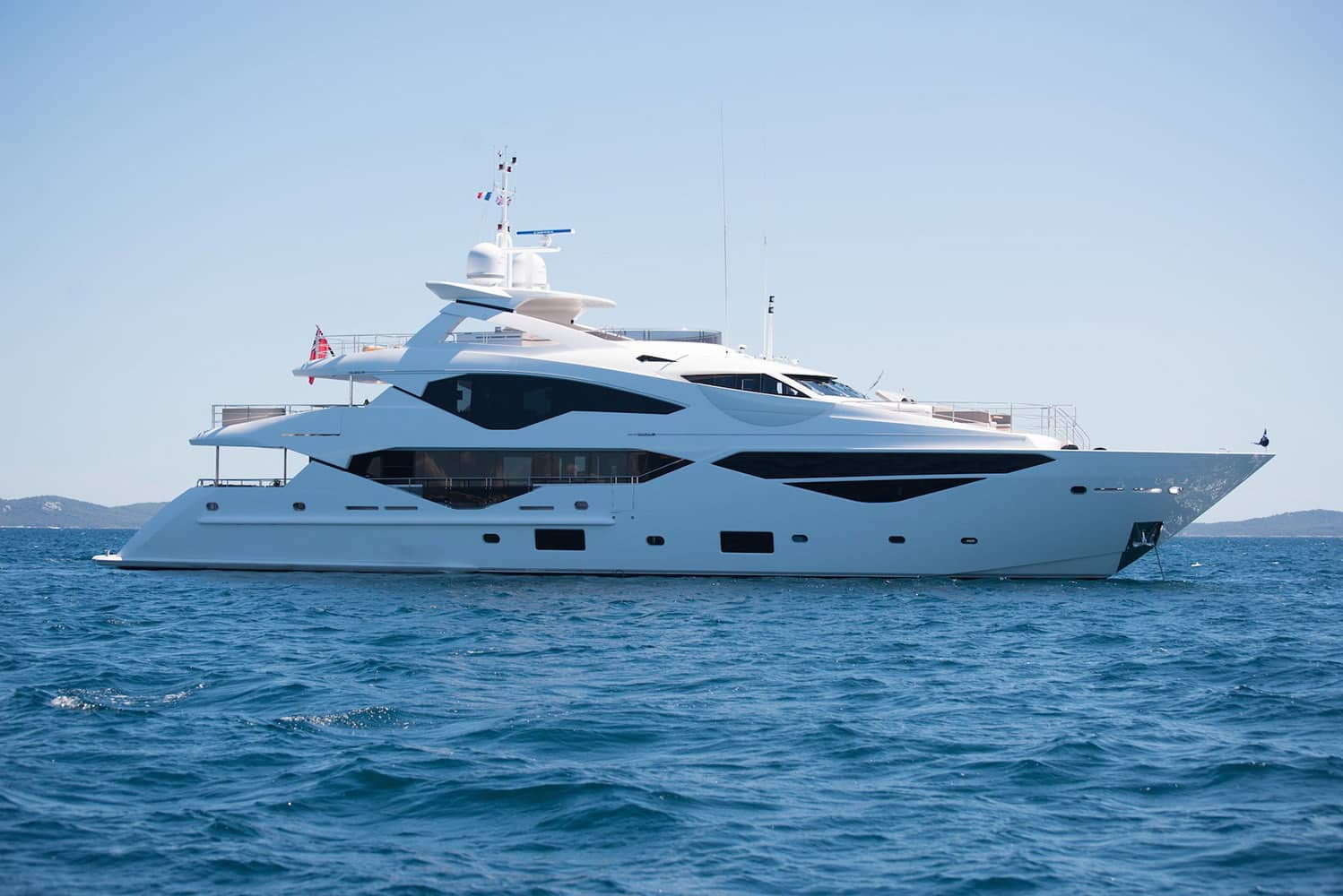 Sunseeker 131 luxury yacht cruising on calm blue waters