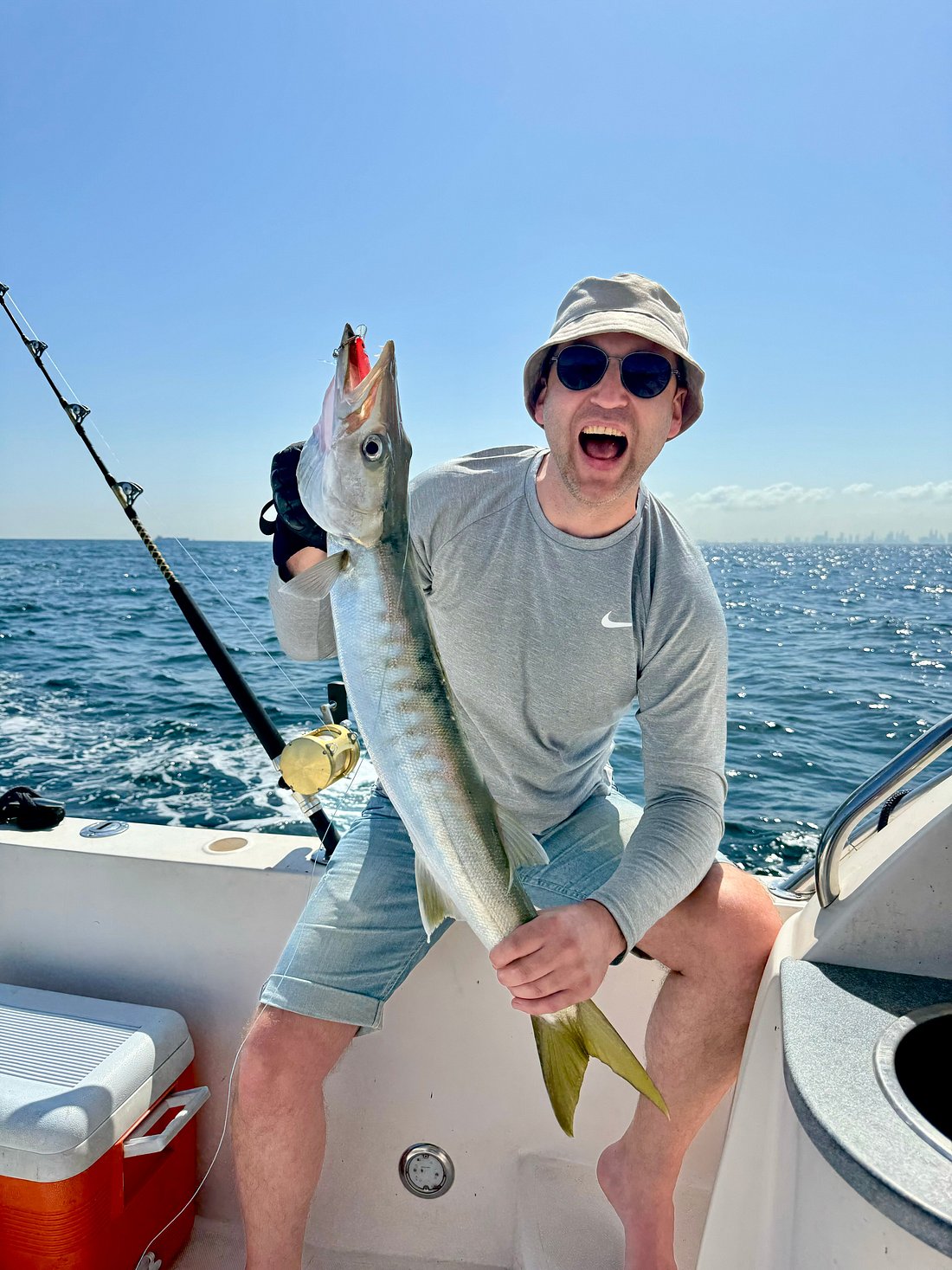 Guest celebrating successful catch during Dubai private fishing experience