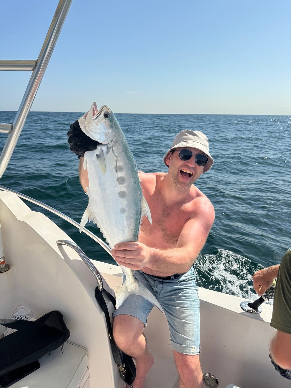 Guest celebrating successful catch during Dubai private fishing experience