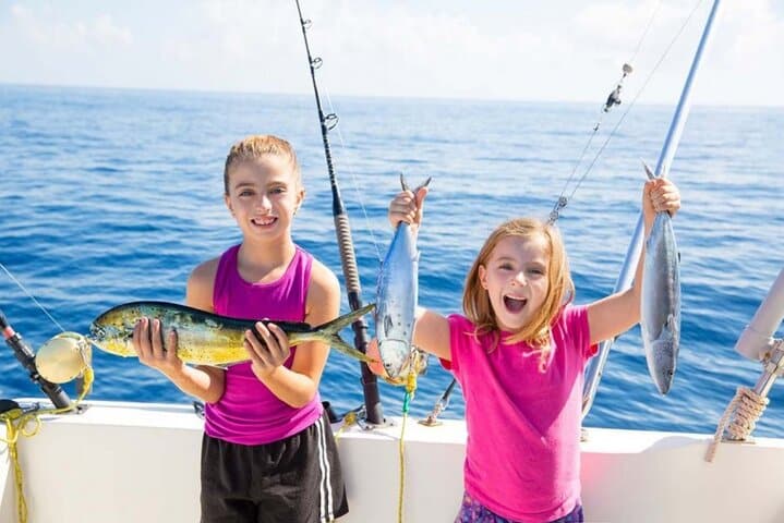 kids enjoying private fishing trip in Dubai with children holding fresh catch