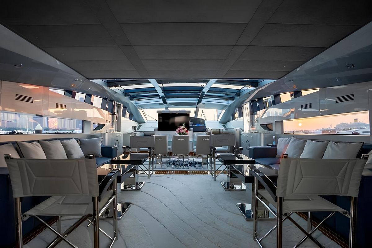 Spacious interior lounge and dining area on Baglietto 110 yacht with panoramic windows and contemporary design
