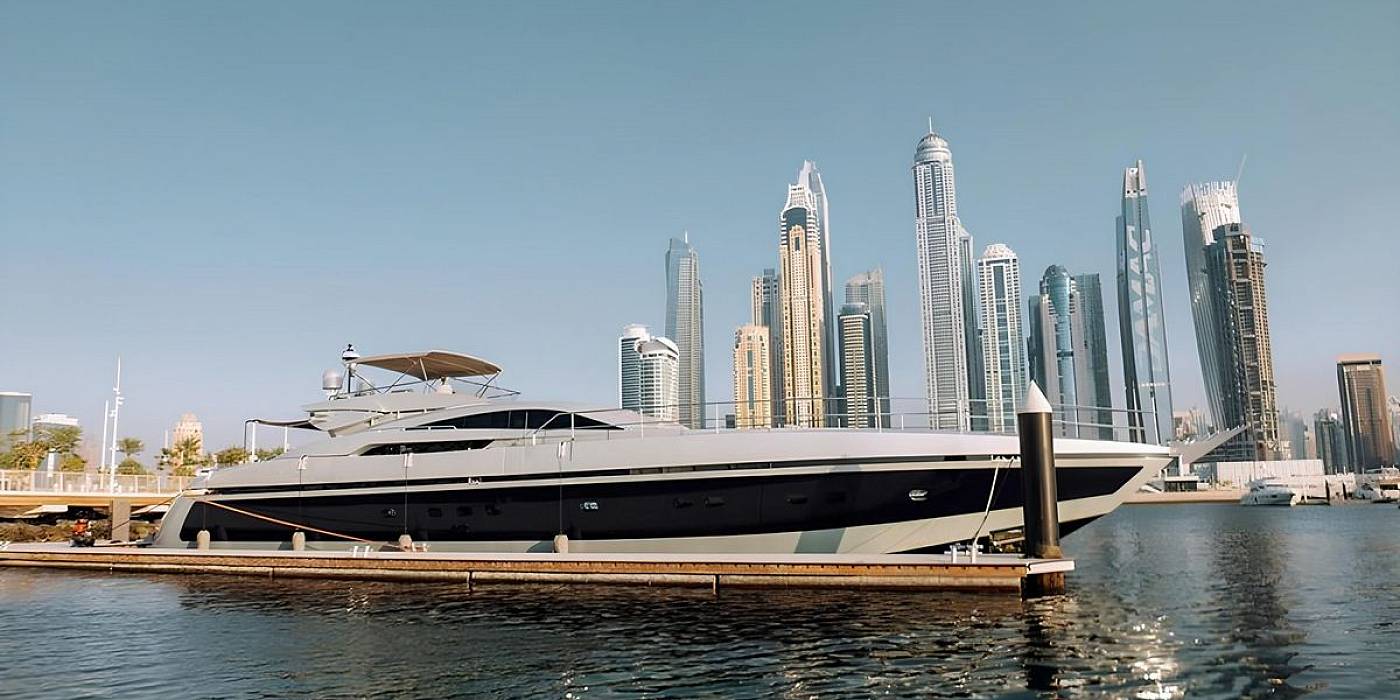 Baglietto 110 luxury yacht cruising near Dubai Marina skyline showcasing sleek profile and spacious sun decks
