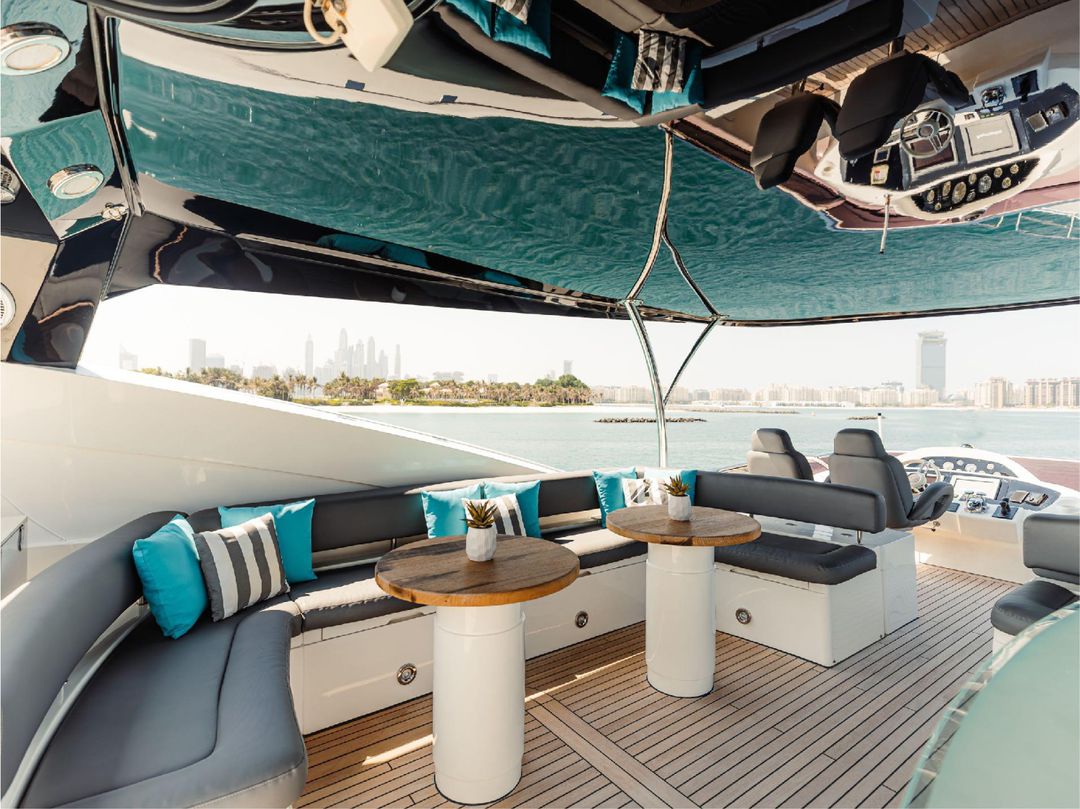 Outdoor lounge area on Notorious yacht with sofas and coffee tables