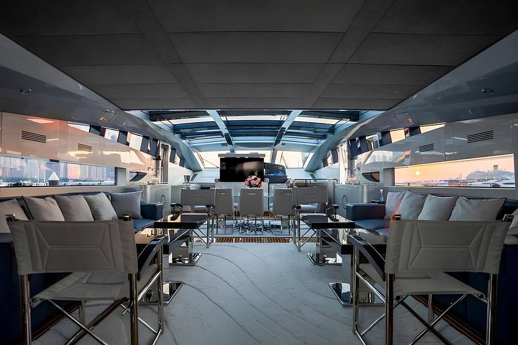 Spacious main salon aboard Baglietto 110 yacht featuring modern lounge seating and panoramic windows
