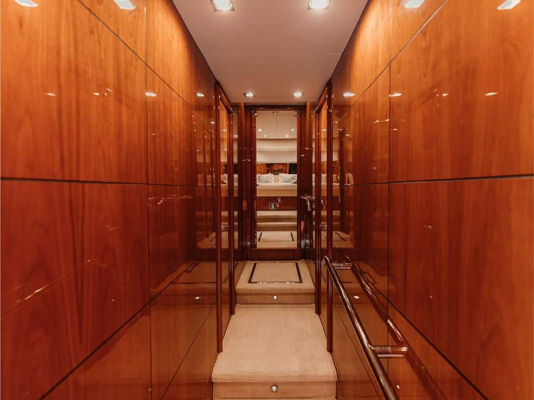 Walk-in wardrobe on Notorious yacht with wooden storage cabinets