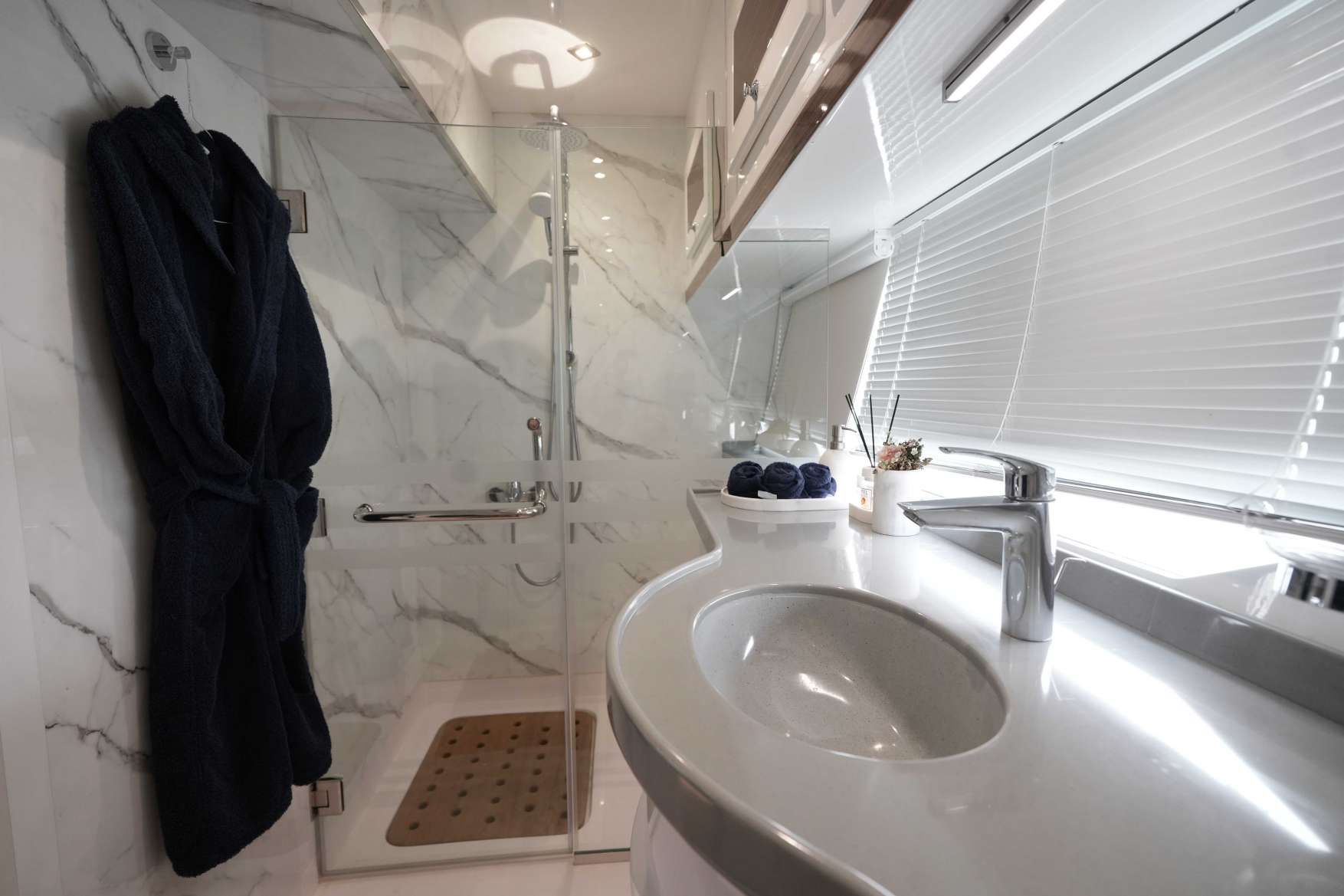 Belle 75 luxury yacht bathroom interior with sink, marble shower, and modern design