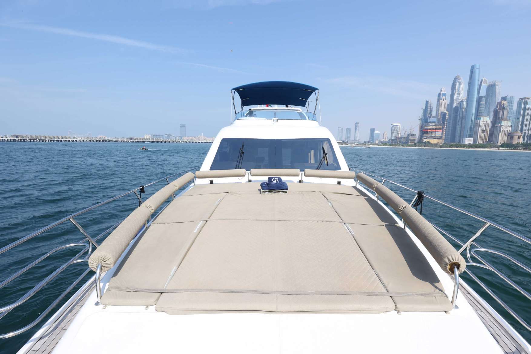 Belle 75 yacht sun deck with sea and skyline view.