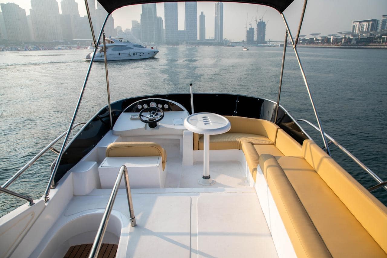 Elan 44 cockpit lounge seating with marina and skyline background