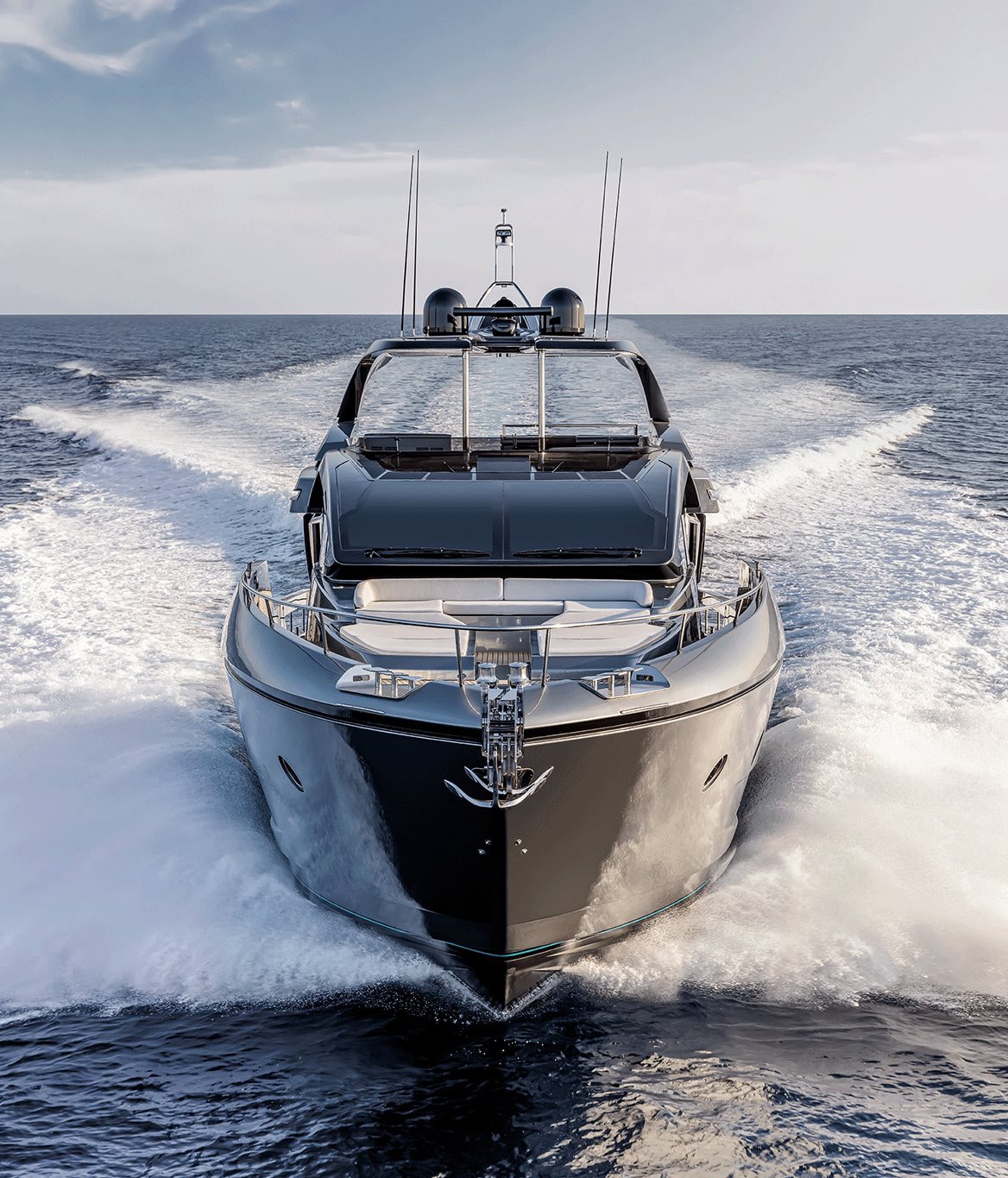 Front view of luxury yacht cruising fast on ocean