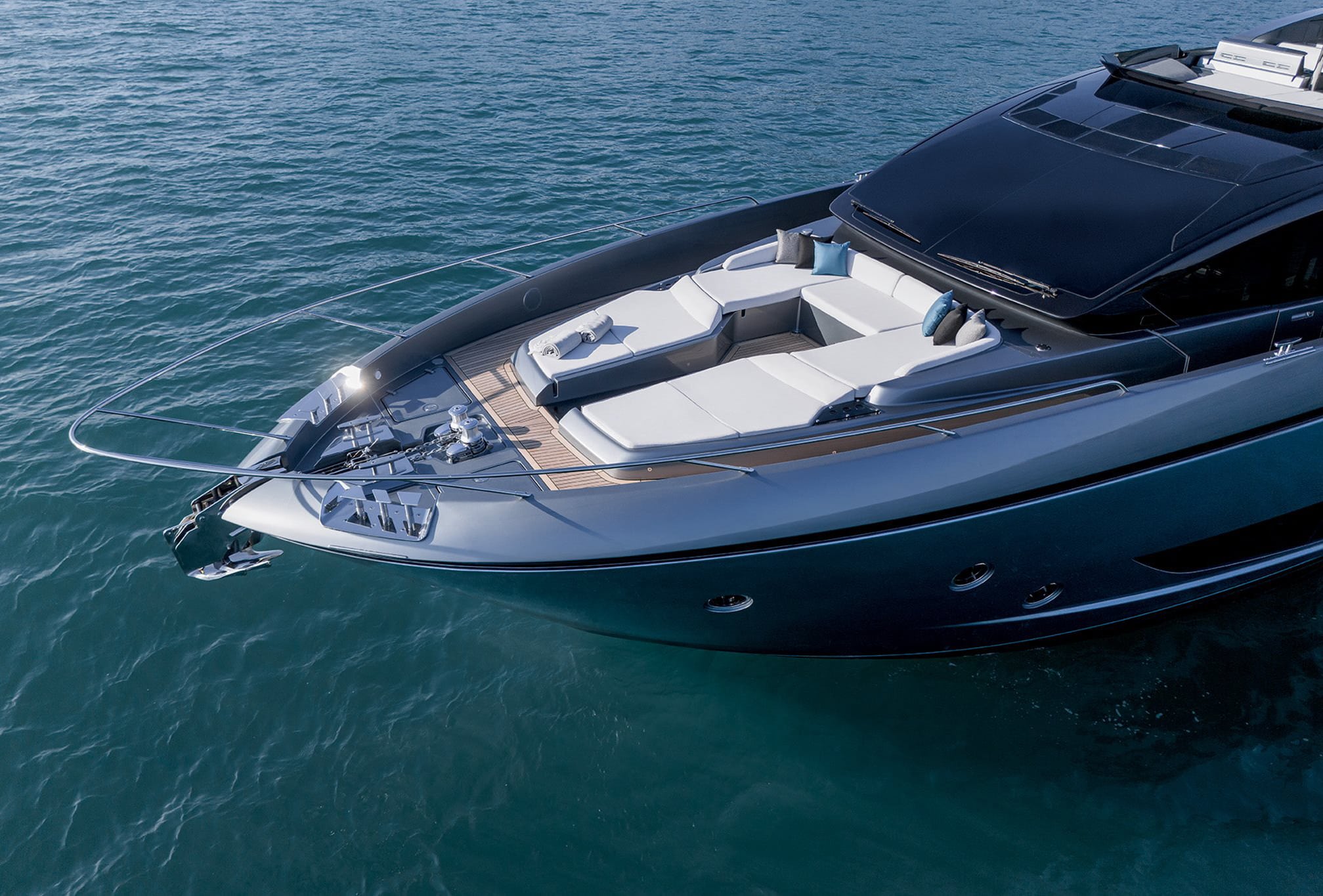Riva 82 yacht bow sunbathing area with cushioned seating