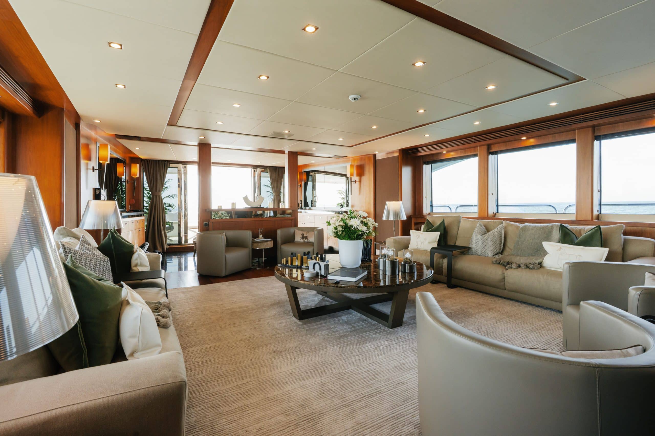Aurora 130 yacht formal living area with curved sofa and luxury décor