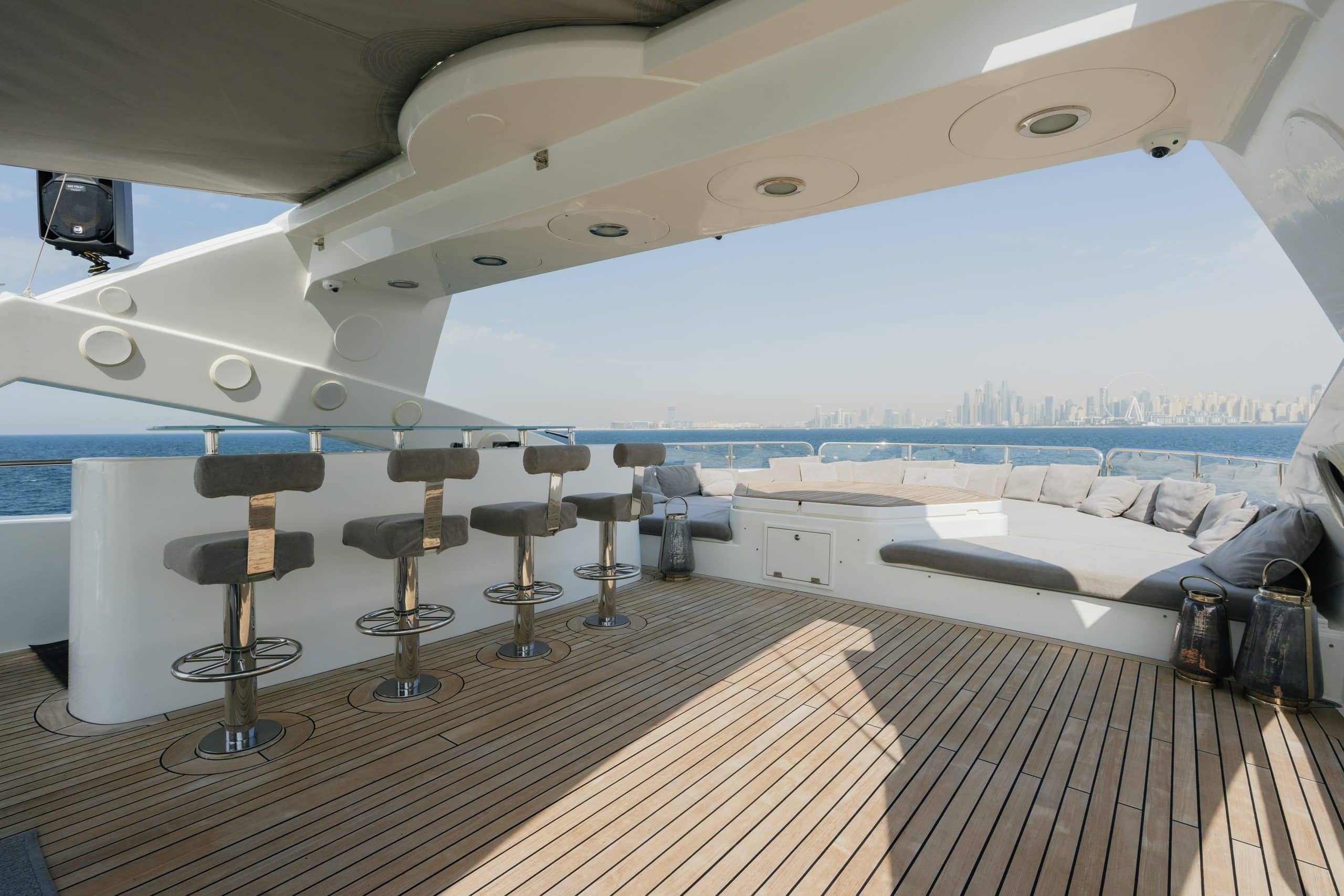 Aurora 130 yacht flybridge deck with bar stools and open sea views