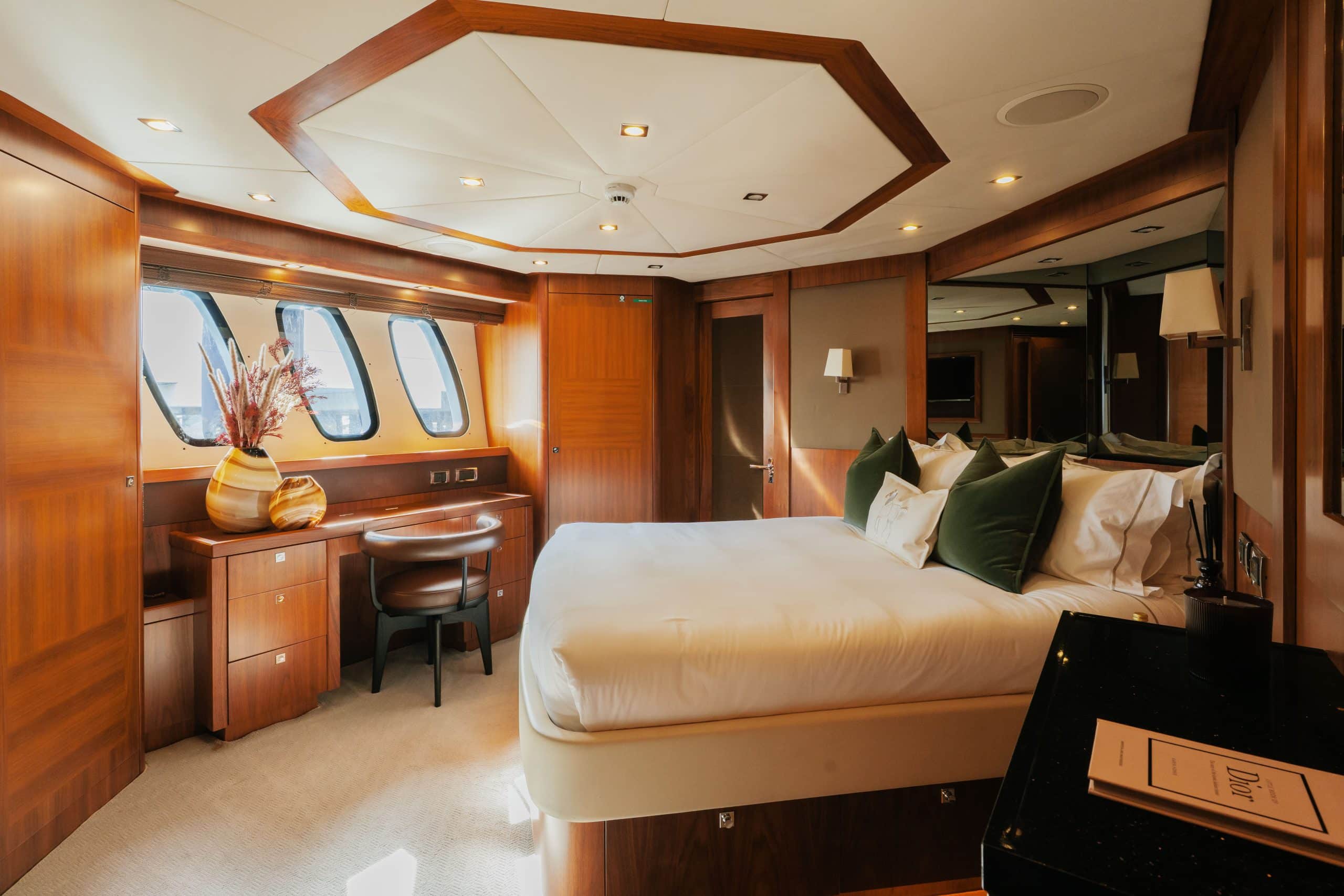Aurora 130 yacht master bedroom suite with wood finishes and large windows