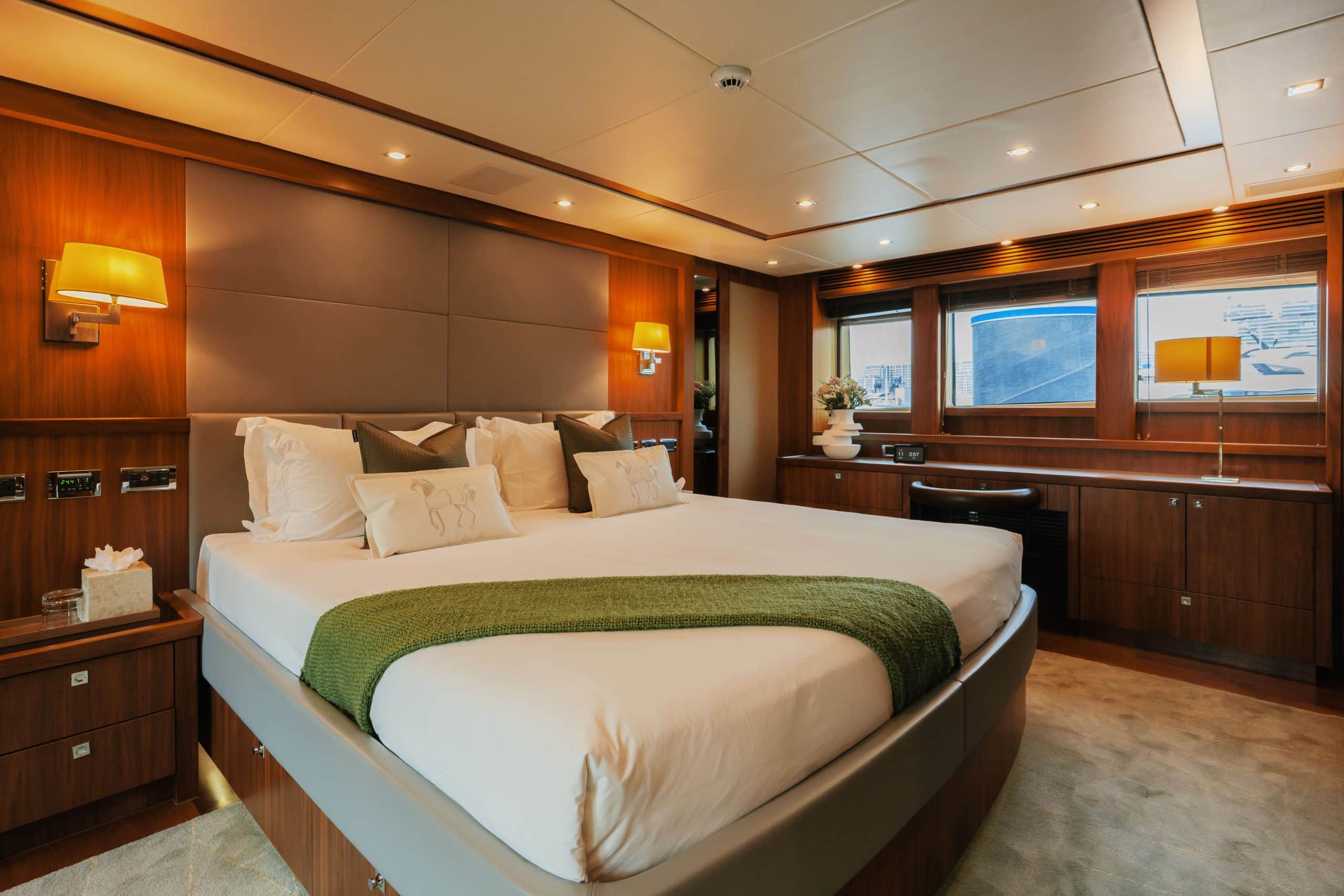 Aurora 130 yacht luxury bedroom with king-size bed and large windows