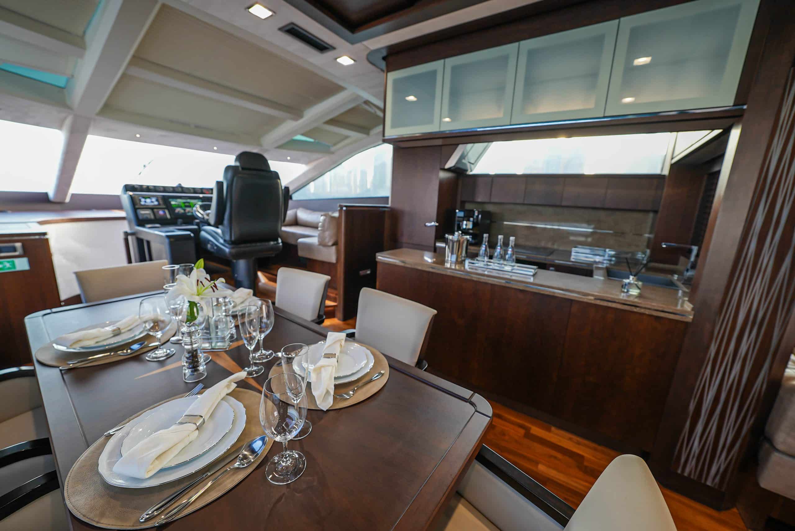 Galeon 780 F1 yacht interior dining area with luxury wood finishes and panoramic windows