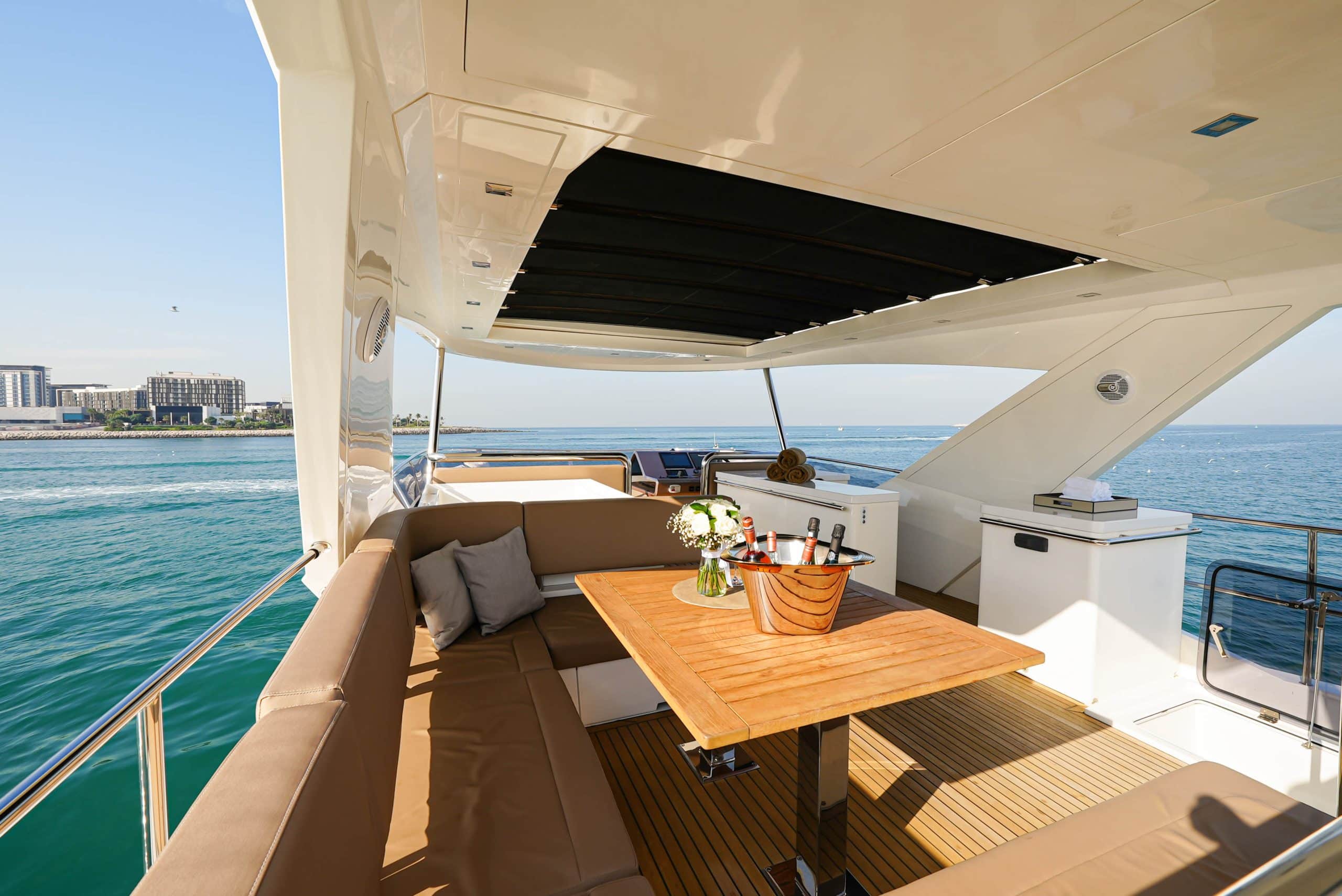 Galeon 780 F1 aft deck dining area with wooden table and sea views