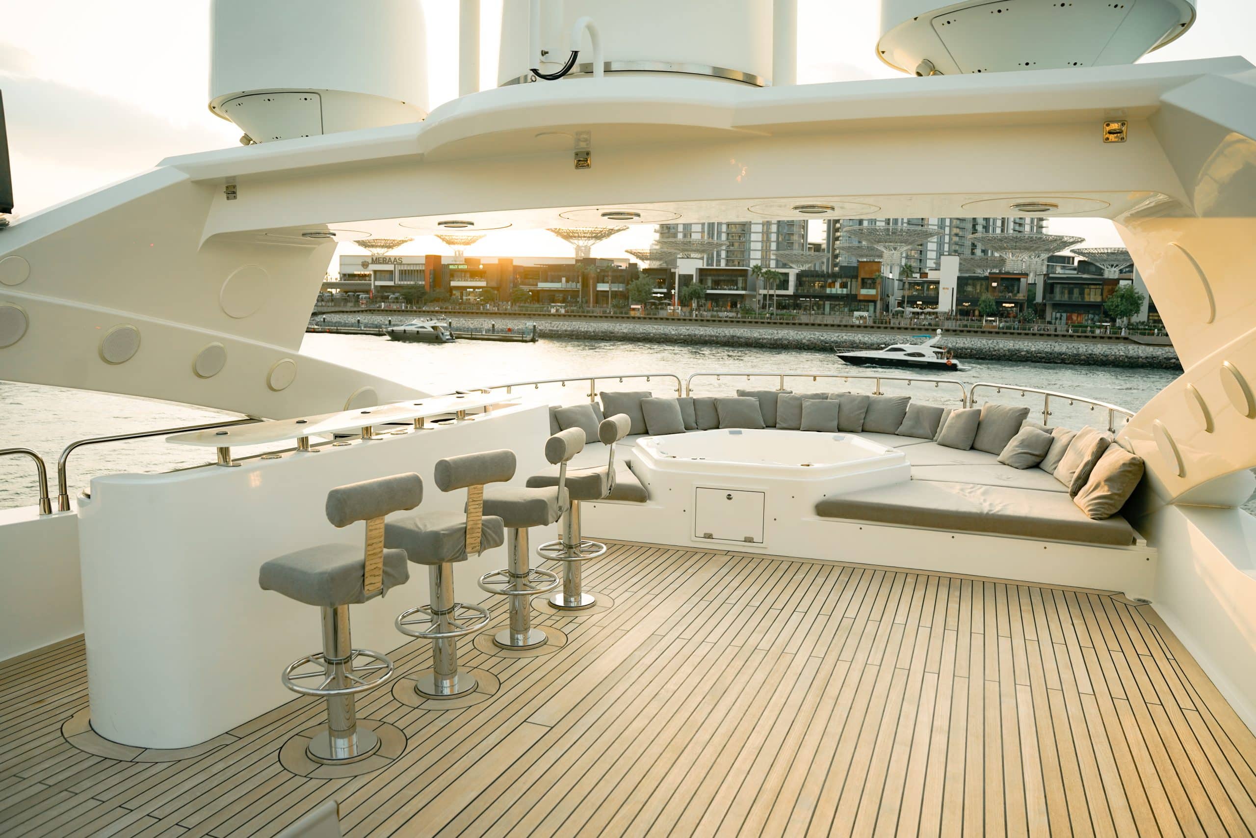 Aurora 130 yacht flybridge lounge with bar seating and wraparound sofas