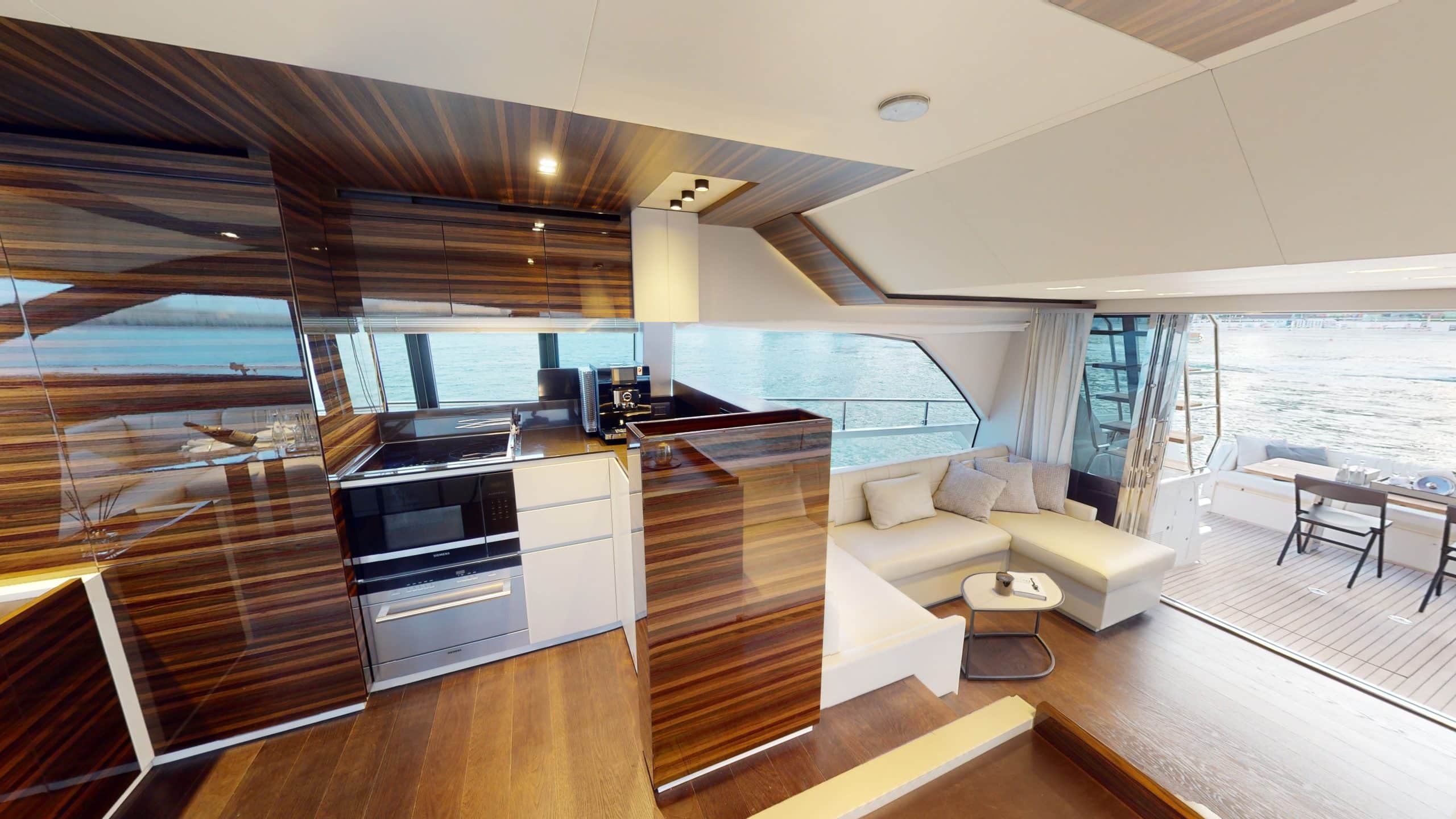 Ferretti 670 yacht modern galley kitchen with wood cabinetry and stainless appliances